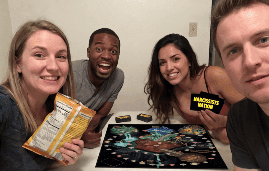 4 friends playing a board game in relaxed settings.