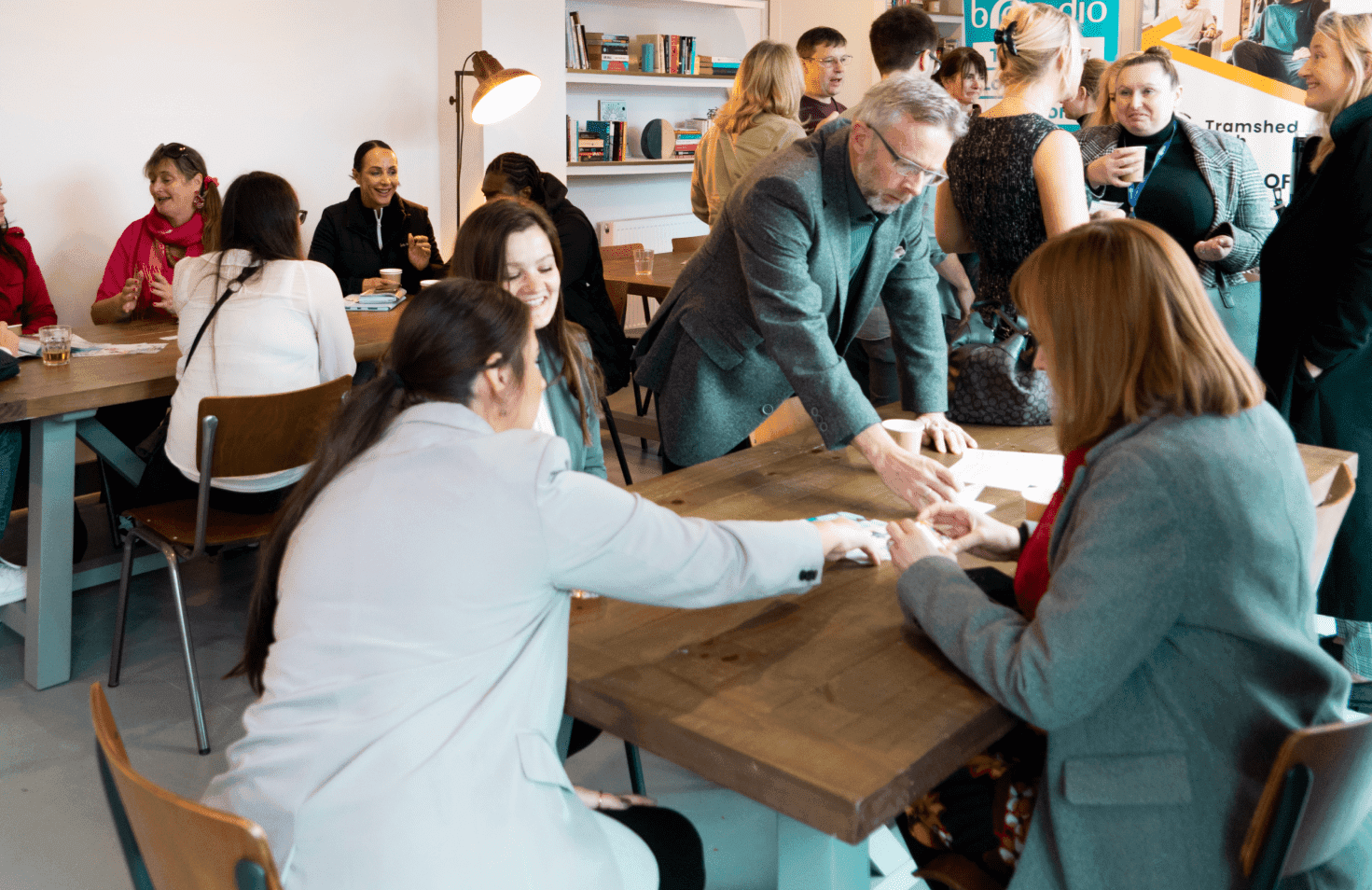 People gathered around a table with papers and cups.