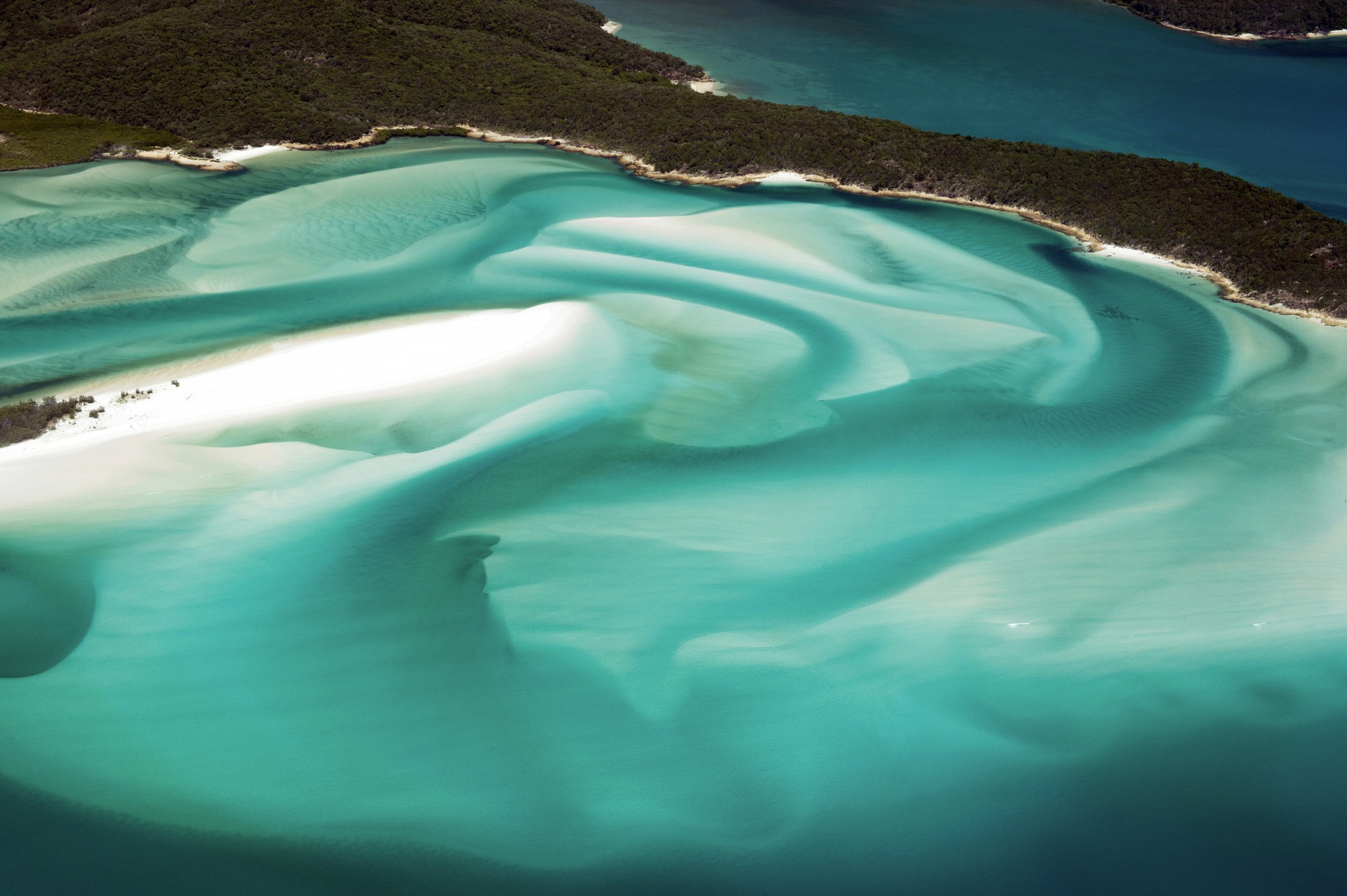Tropical beach with umbrellas and lounge chairs.