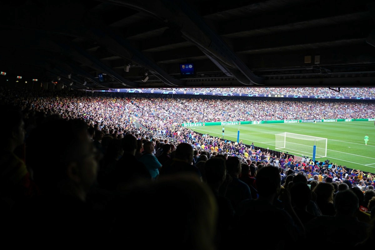 People watching football in a stadium