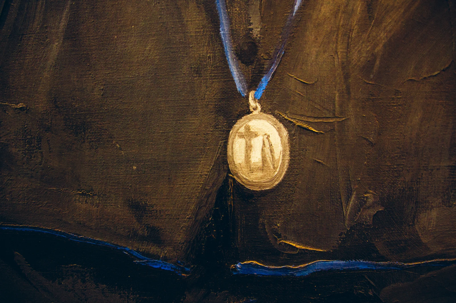 Close-up of a religious medal on dark fabric