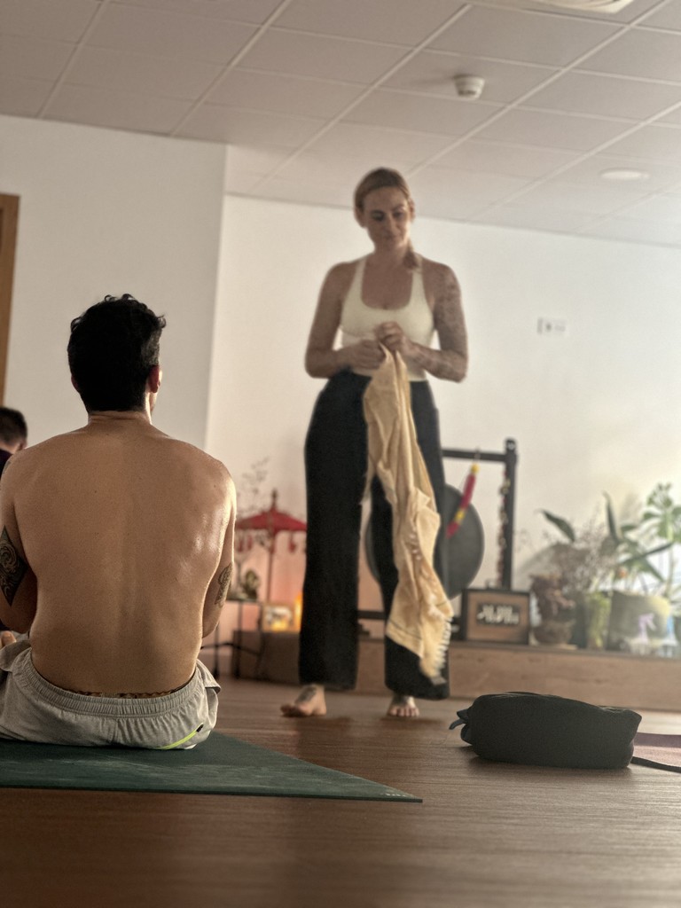 Woman practicing aerial yoga with white hammock