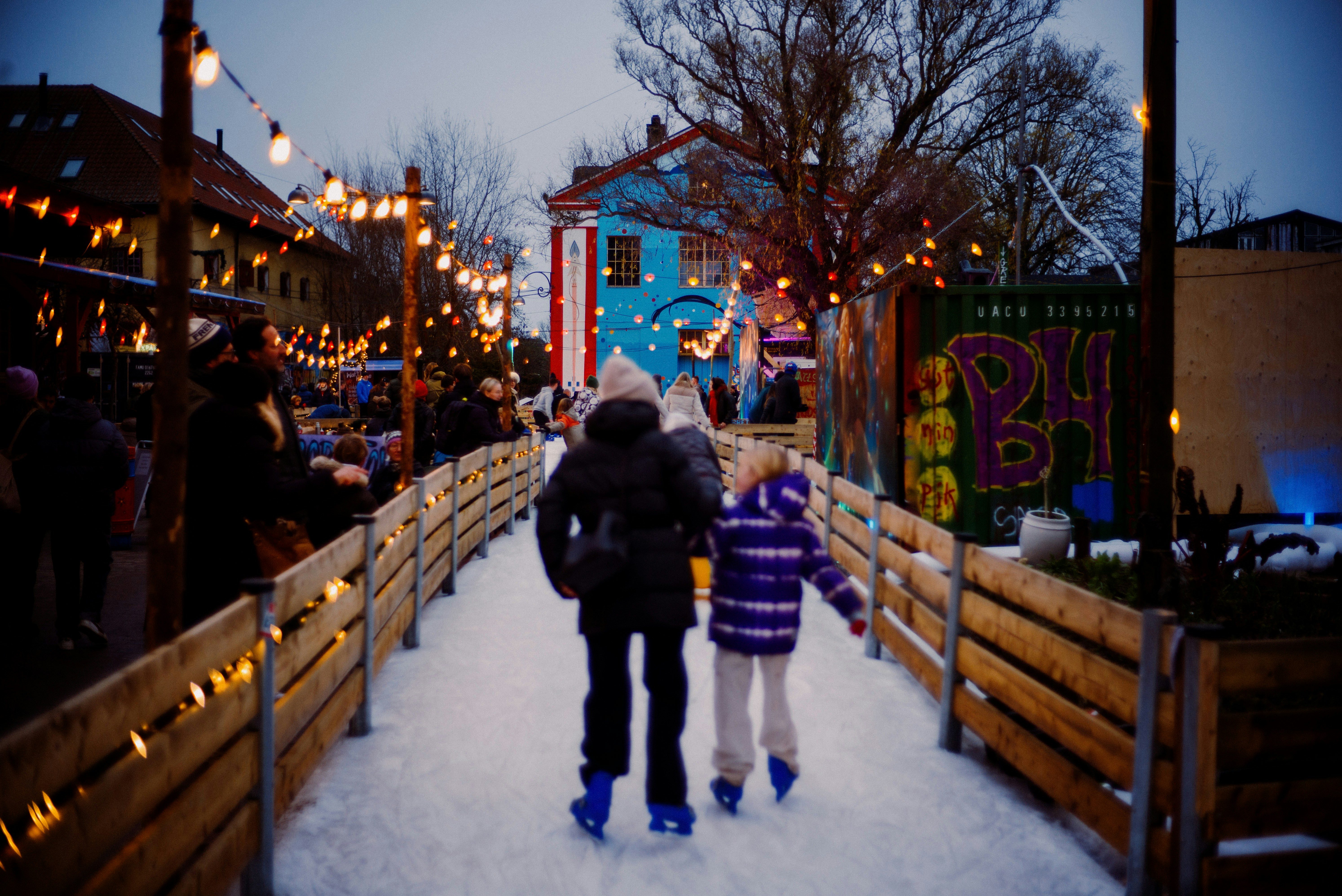 A couple of people that are standing in the snow