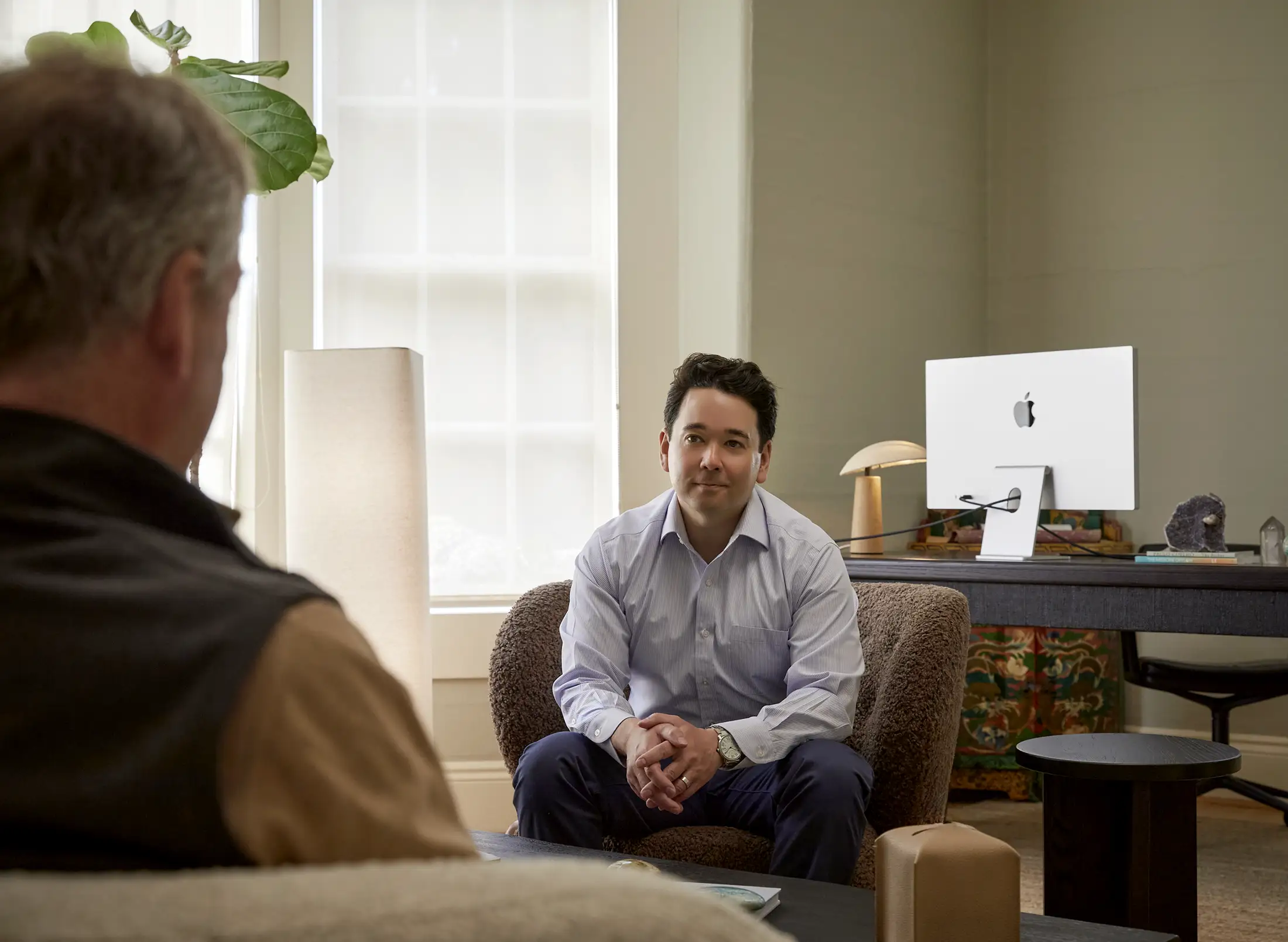 Dr. Keith Desrochers speaks with a patient during a consultation in his office at BlueWave Medicine.