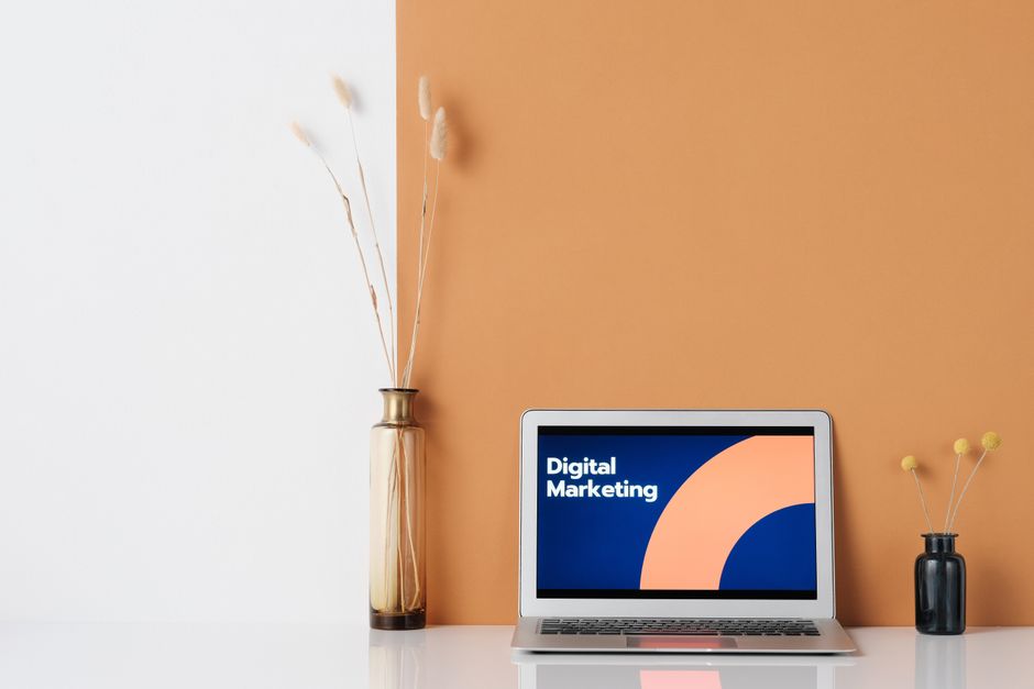 A laptop screen displaying various marketing channels like search, social, and email - digital marketing services online