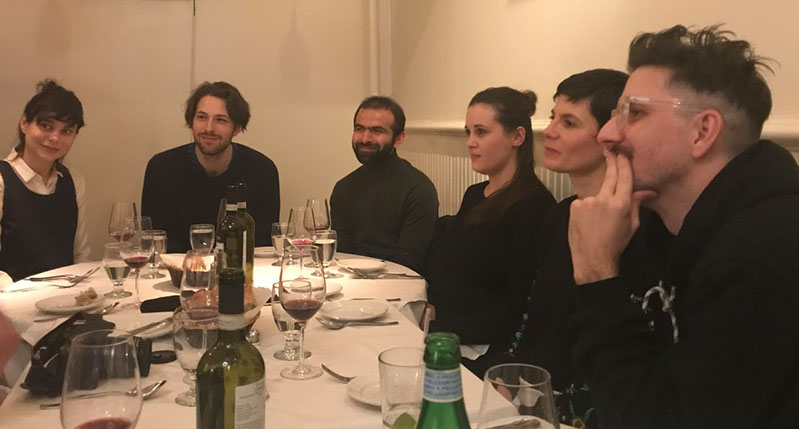A photo of a group of people sitting at a table.