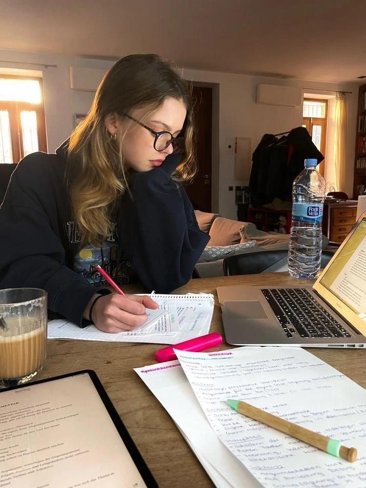 girl using laptop and drinking coffee