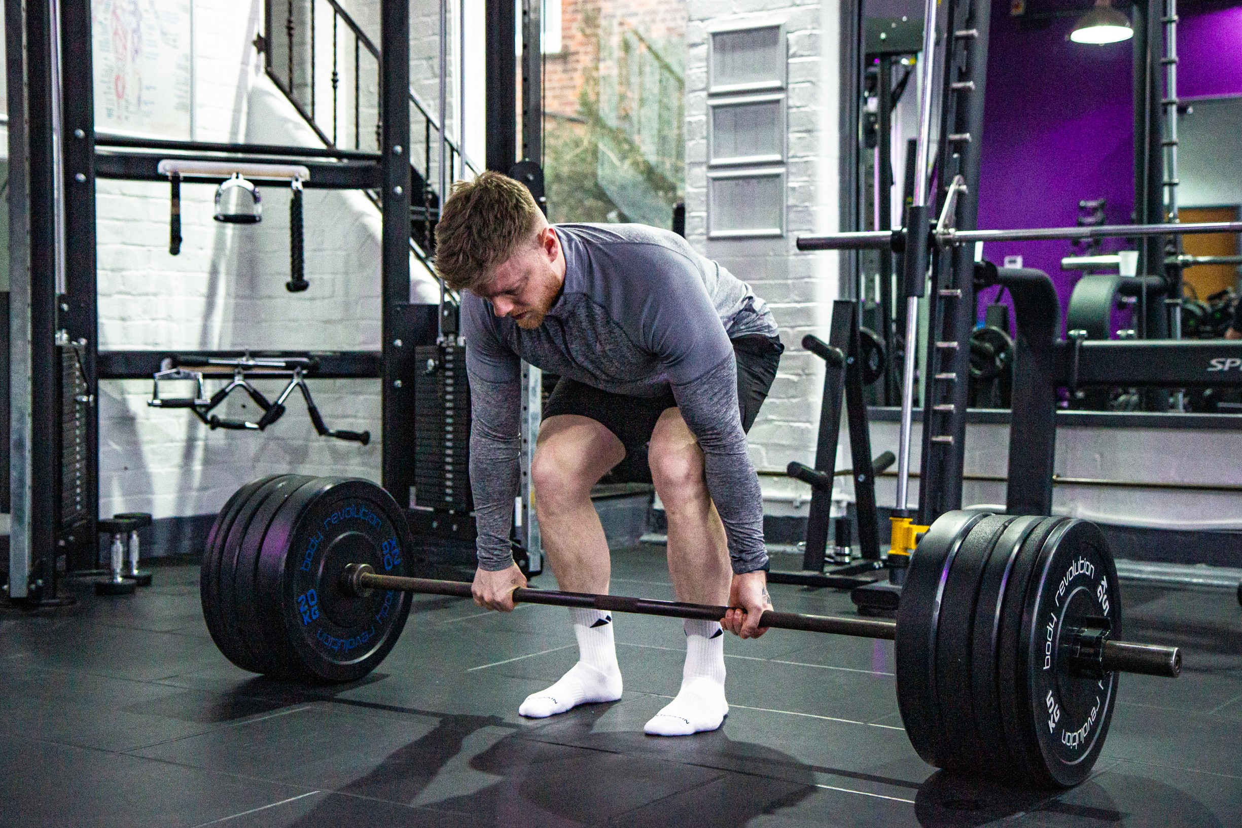 A man doing deadlifts in the gym for resistance training