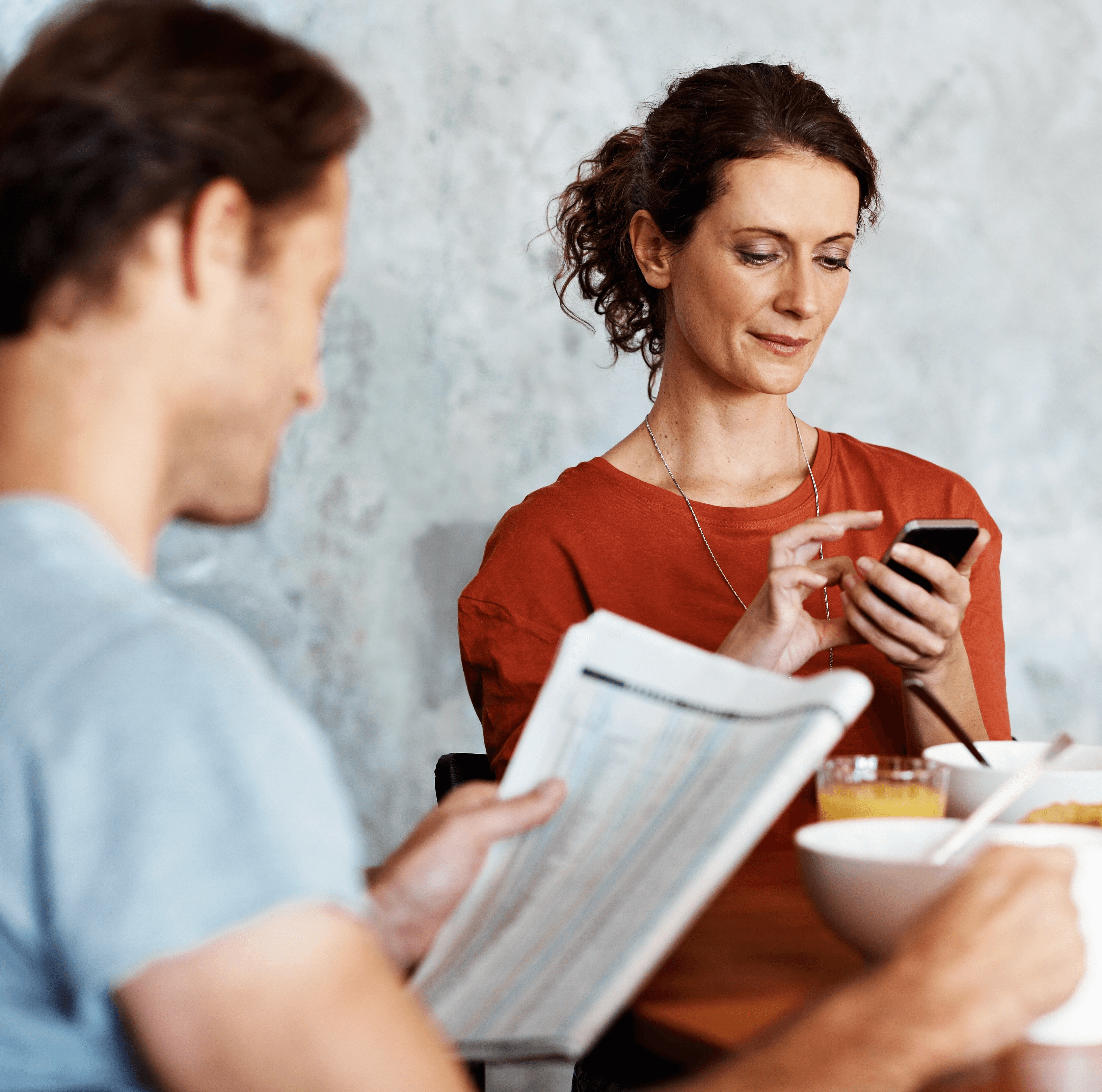 Couple in kitchen getting notification on mobile phone