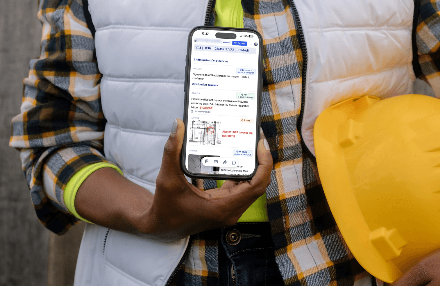 A woman on site handing her phone with a report in there