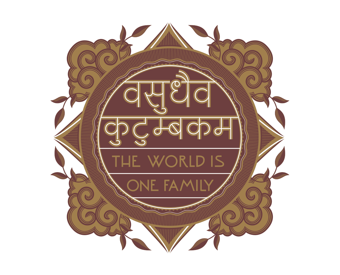 A circular emblem with a dark brown background features a central text in gold script that reads “THE WORLD IS ONE FAMILY.” Surrounding the text are stylized gold floral and leaf motifs. The emblem has a symmetrical design with pointed triangular shapes at the center and outer edges.
