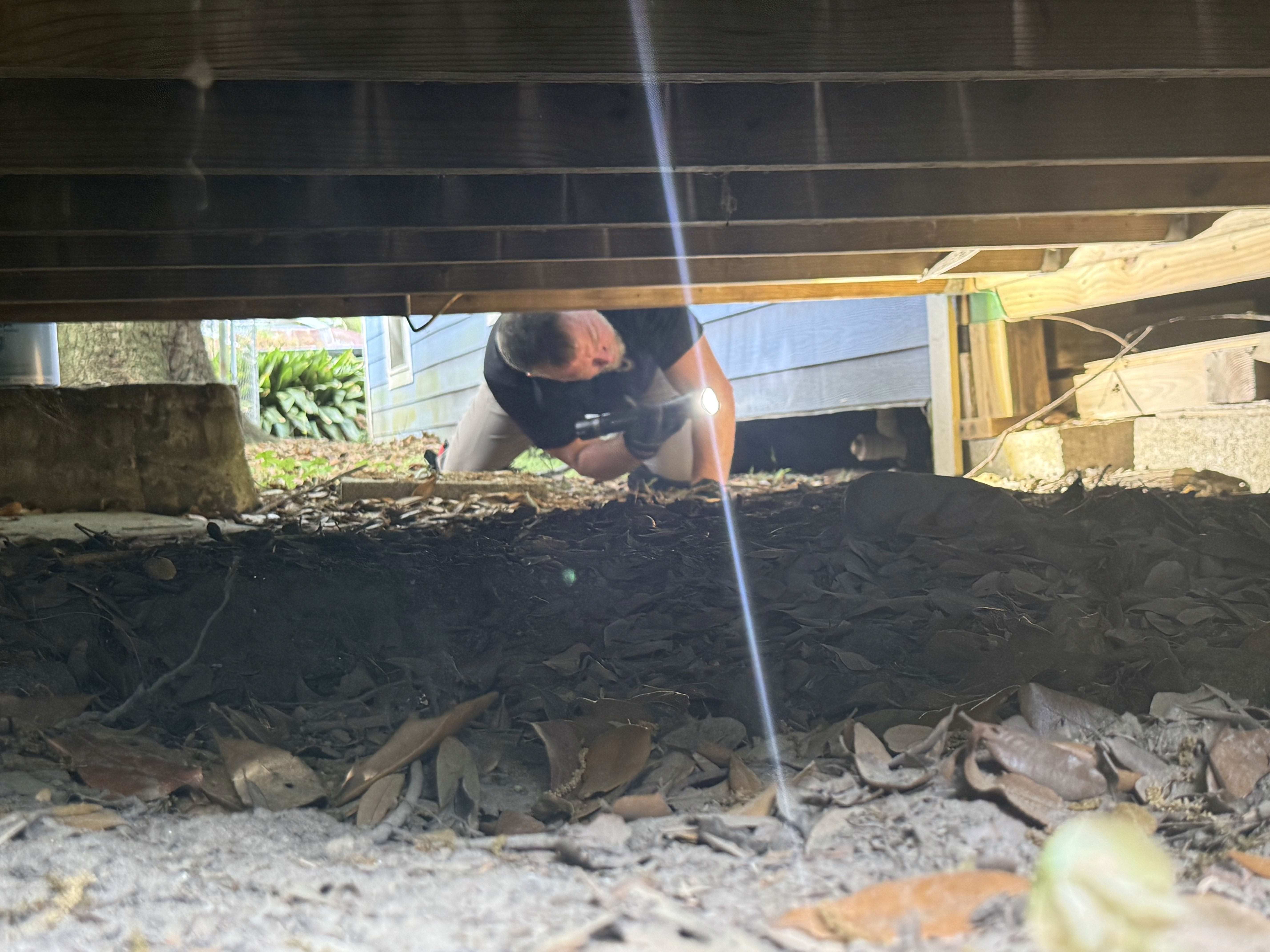 Home inspector checking crawlspace Mississippi home