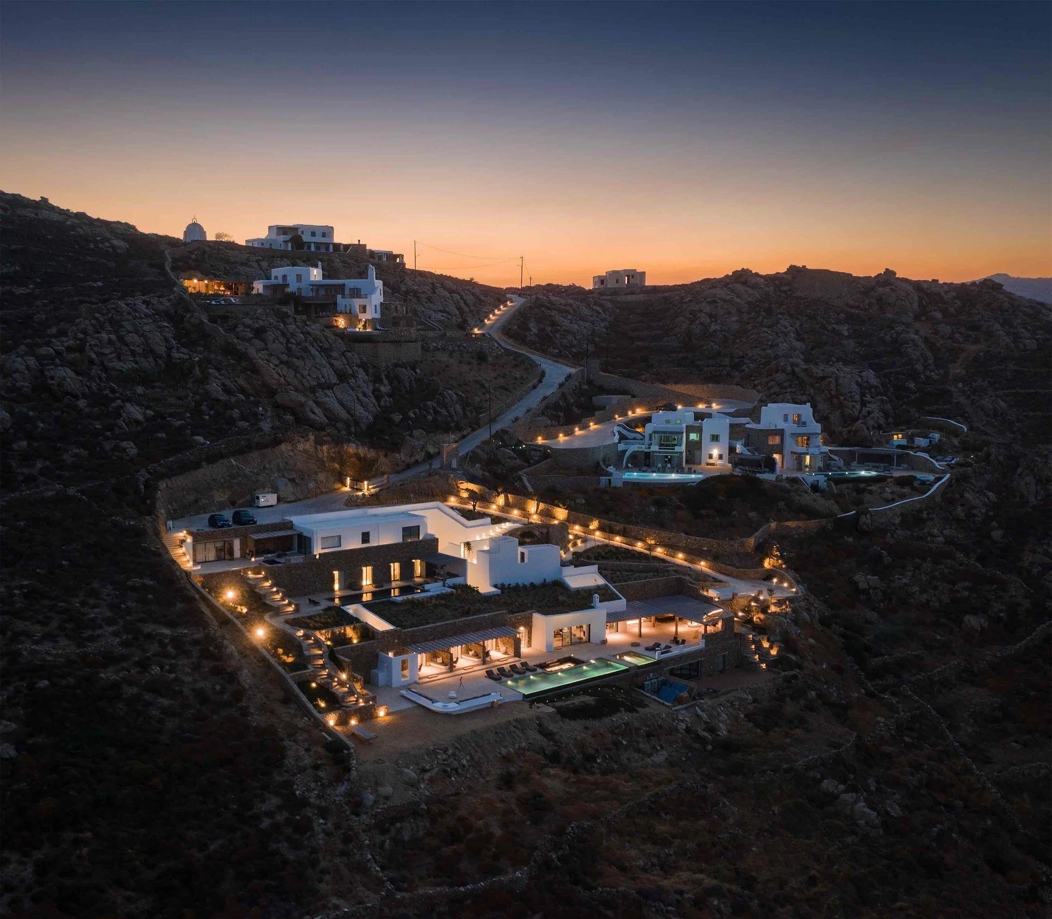 photo of house near cliff and body of water