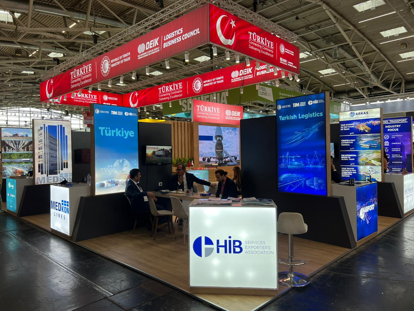 VIP collaboration and meeting areas within the DEİK pavilion, including a private glass meeting room and open zones.