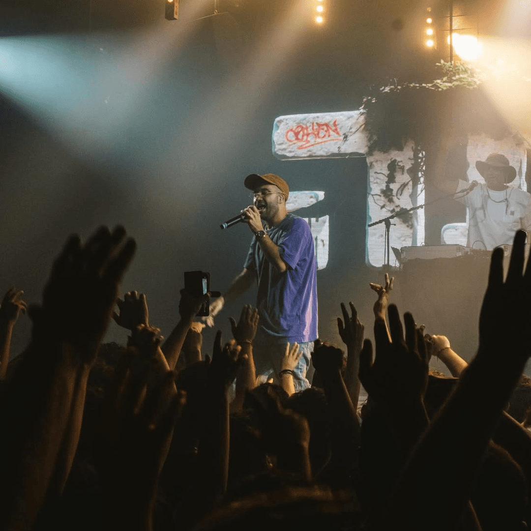 Cohen Performing Live with the visuals in the background