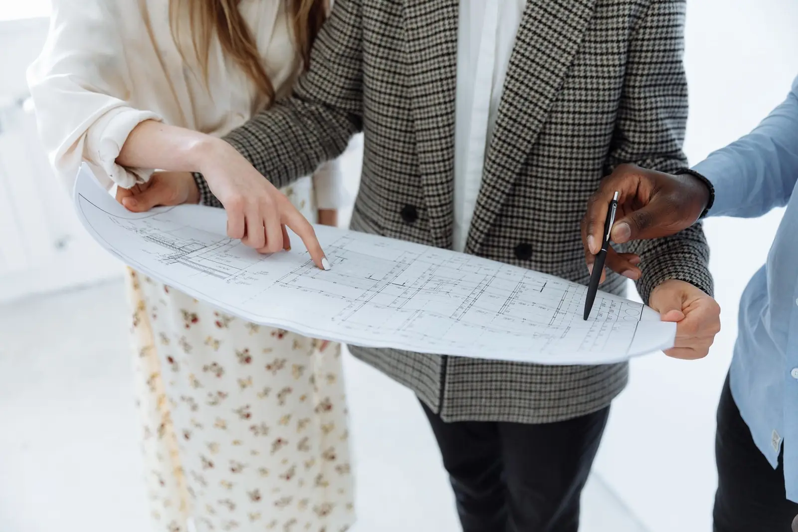 Adults reviewing schematic floor plans on a table