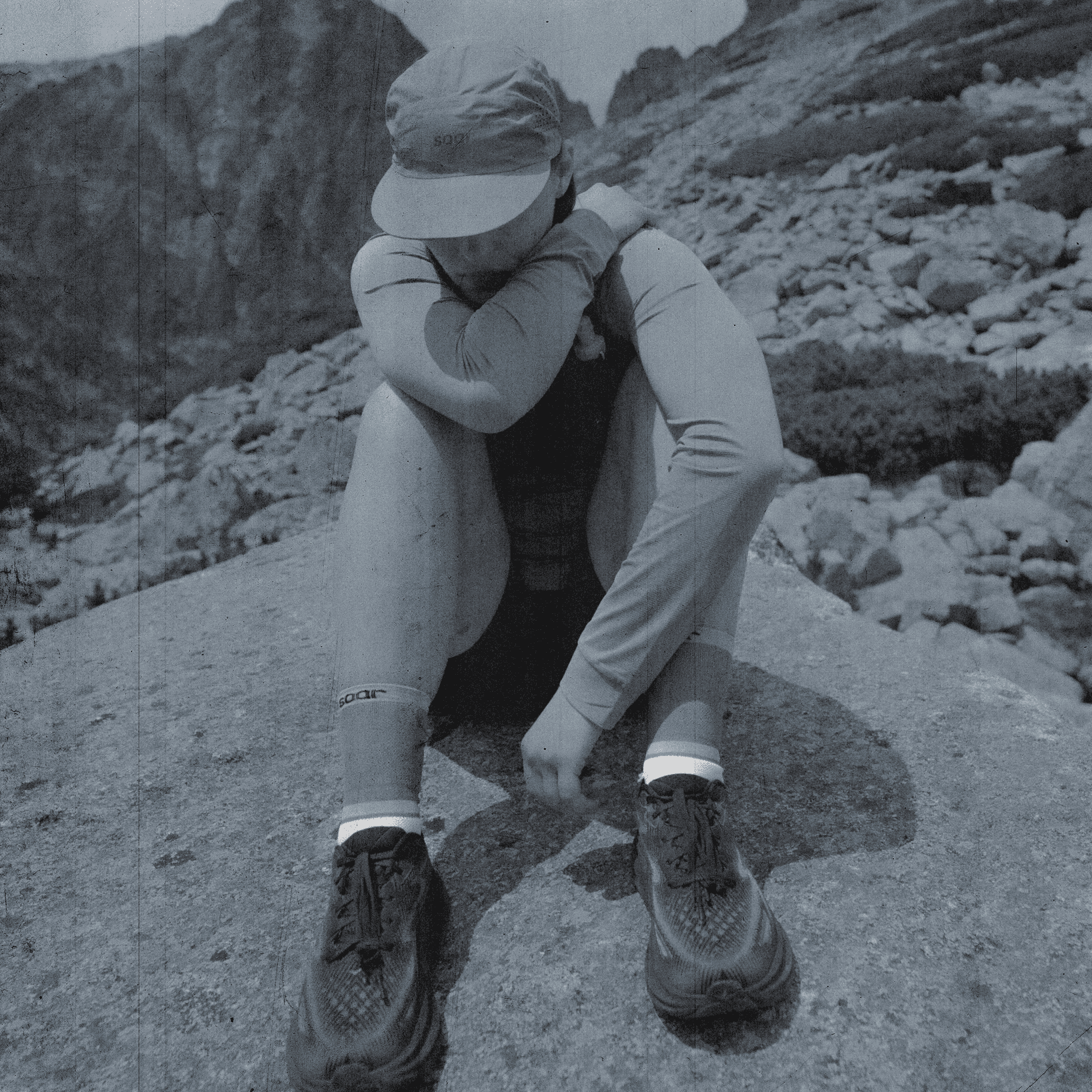 picture of a woman sitting on a rock.