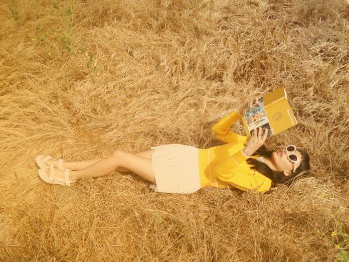 Silhouetted crowd observes pyramid through large windows.