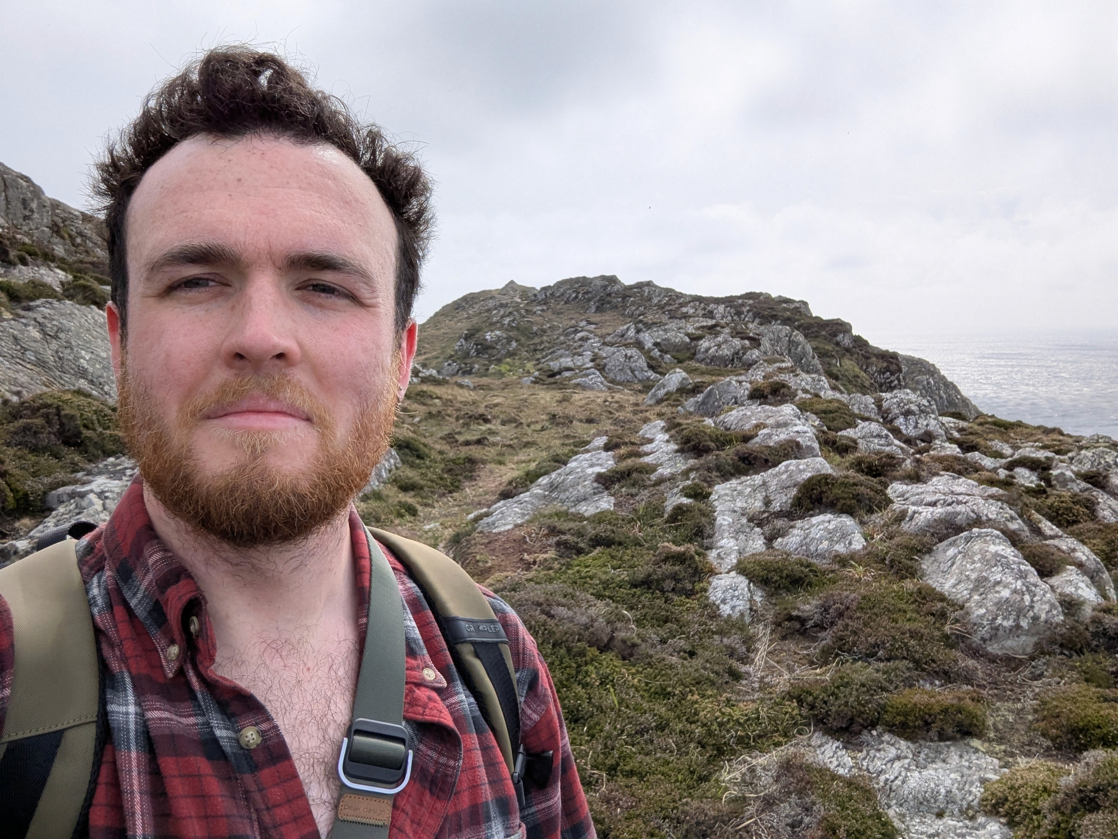 man filming on beach