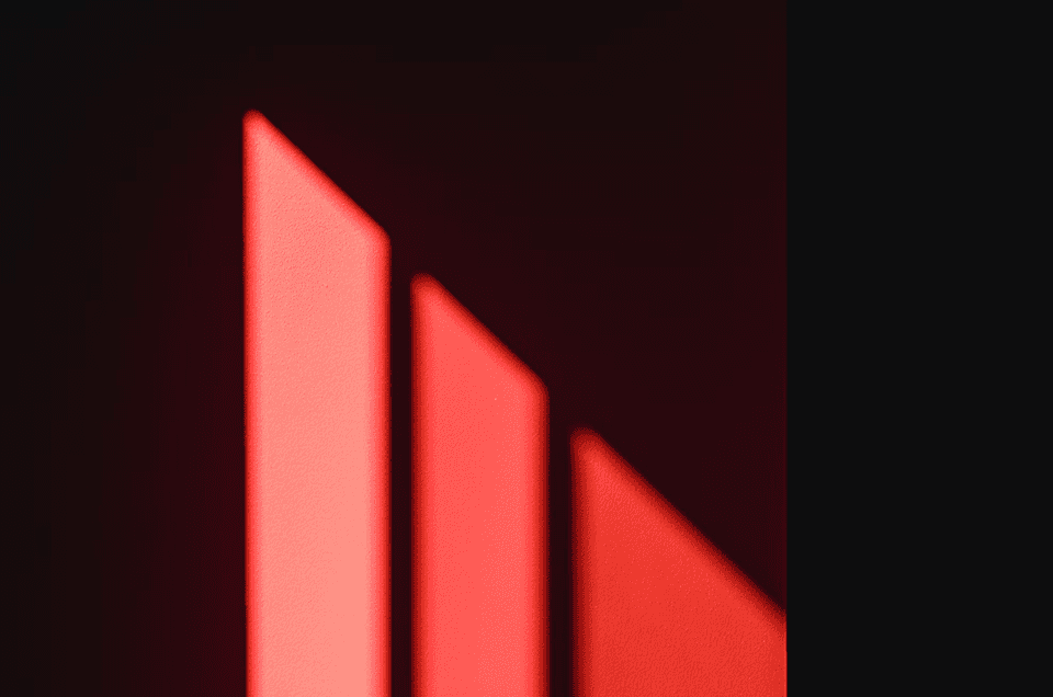 Red glowing geometric shapes on a dark background, symbolizing the best ColdIQ alternatives for B2B growth in 2026
