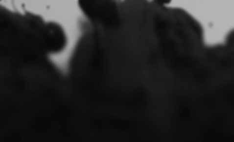 Dark abstract image of black smoke or ink clouds against a light background