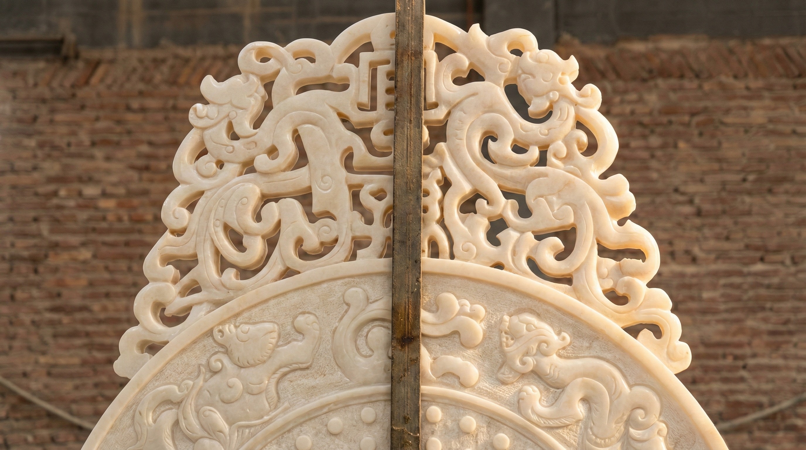 Intricate openwork (pierced) carving on the crest of a white jade screen, handcrafted by NOVA STONE.