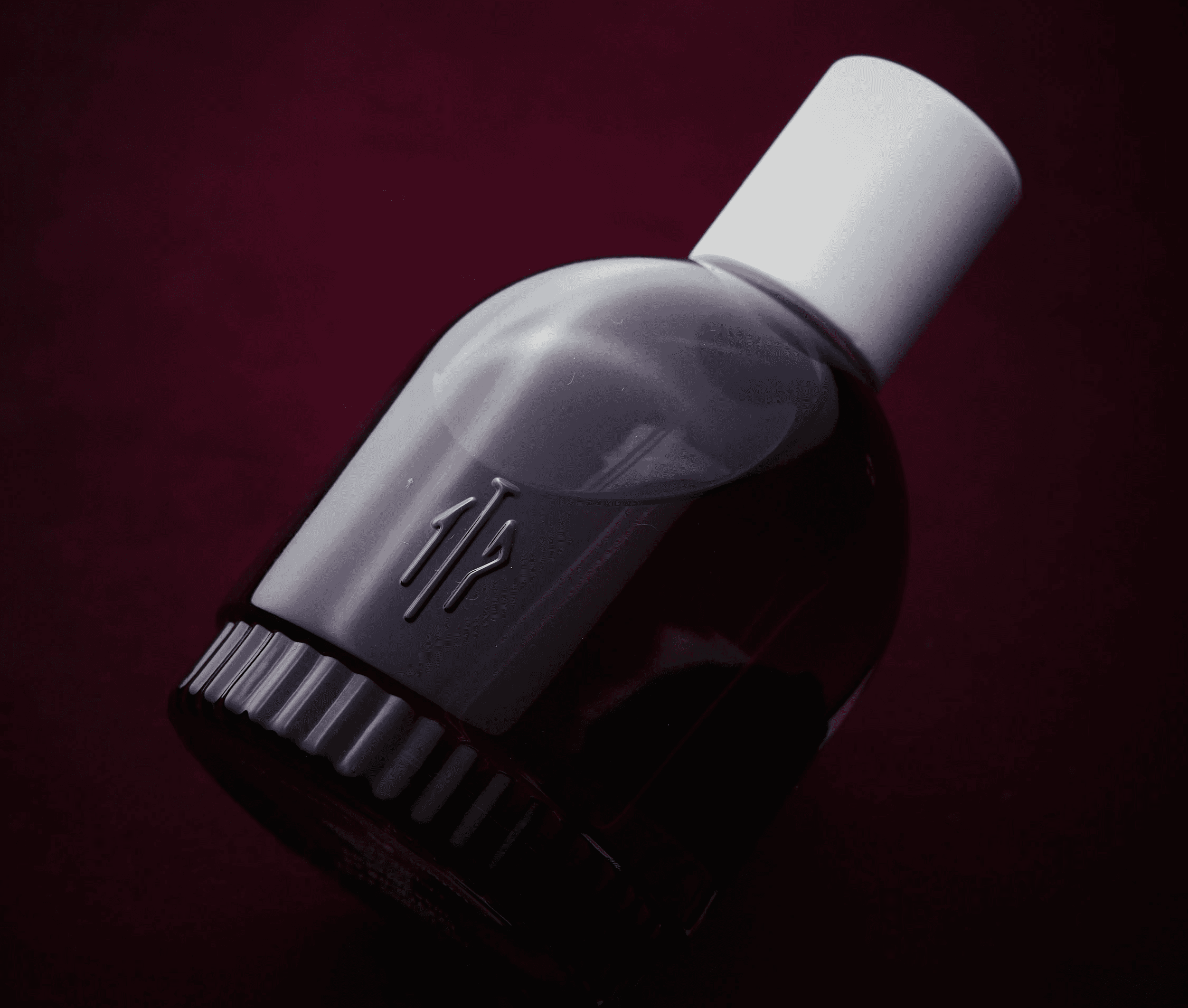 A close-up of a hand wearing multiple decorative rings against a blue background.