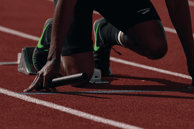 Athlete at the starting blocks on a running track, close-up