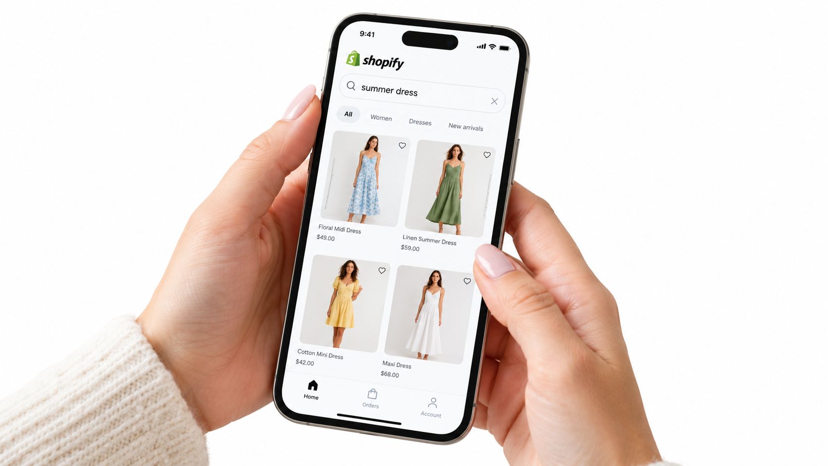 A close-up view of a person holding a smartphone showing the Shopify mobile e-commerce shopping app interface.