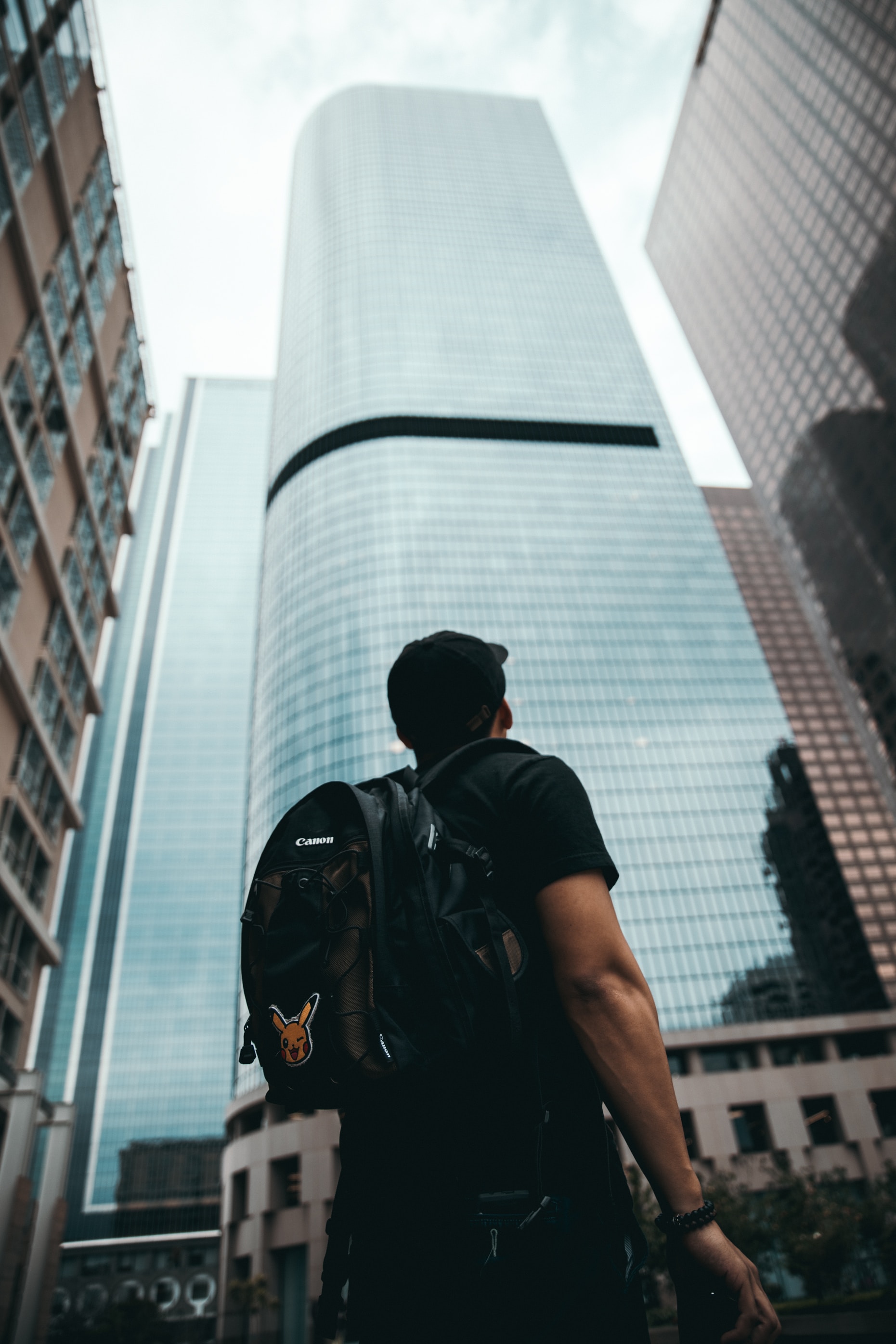 Determined person gazing upon high buildings