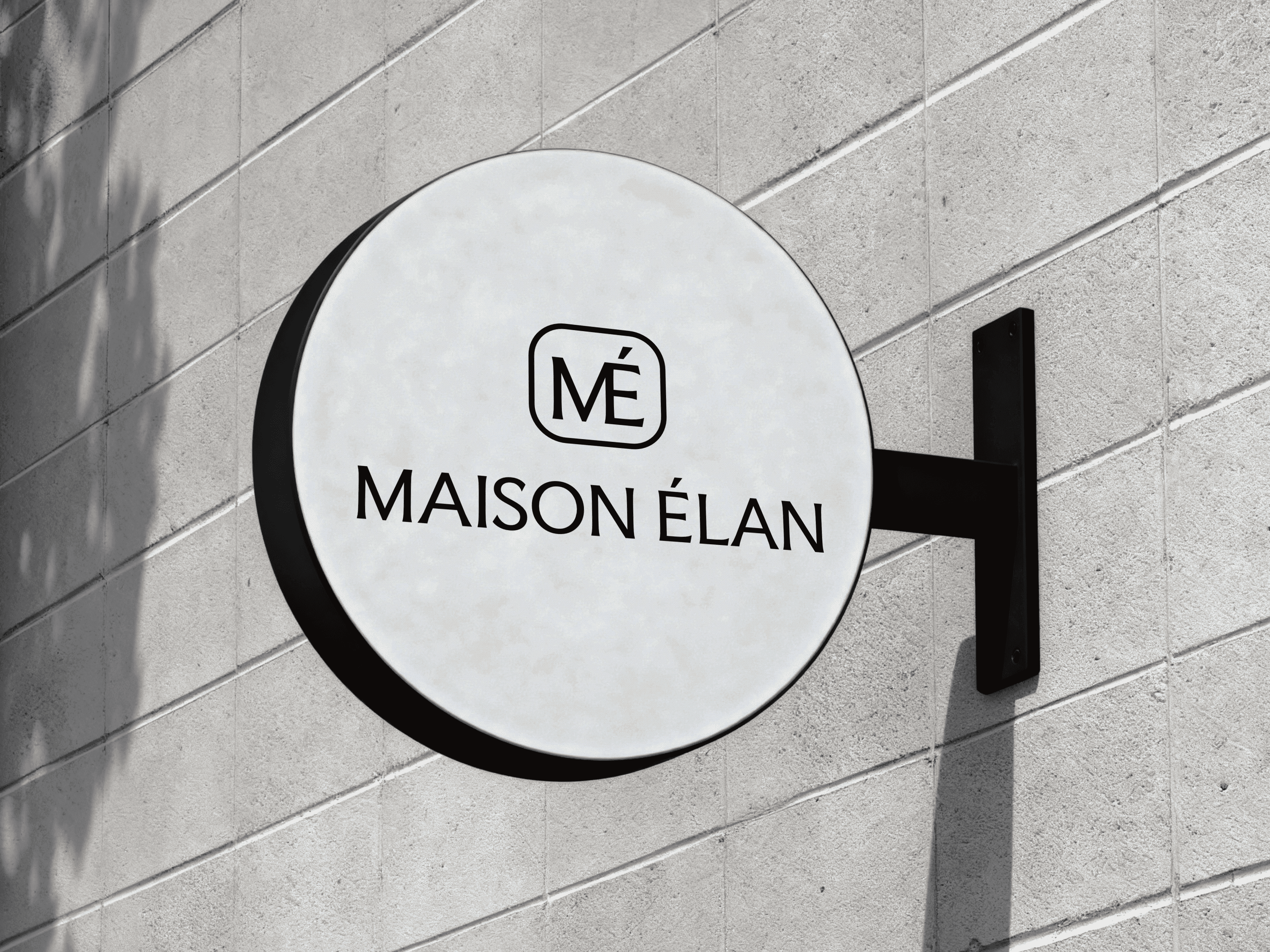 A round shop sign for the brand Maison Élan.