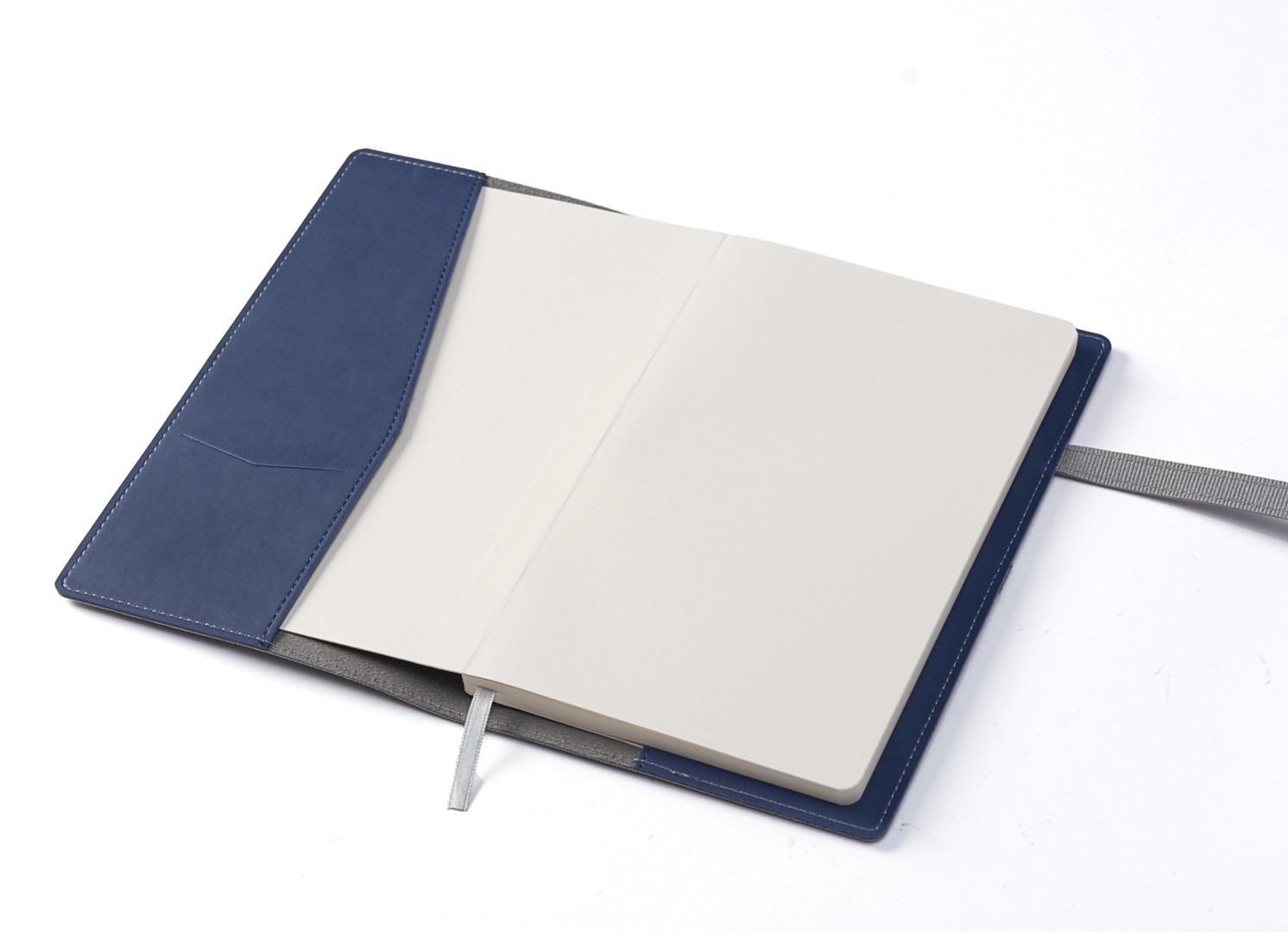 Open cover revealing blue interior flap pocket and blank page.