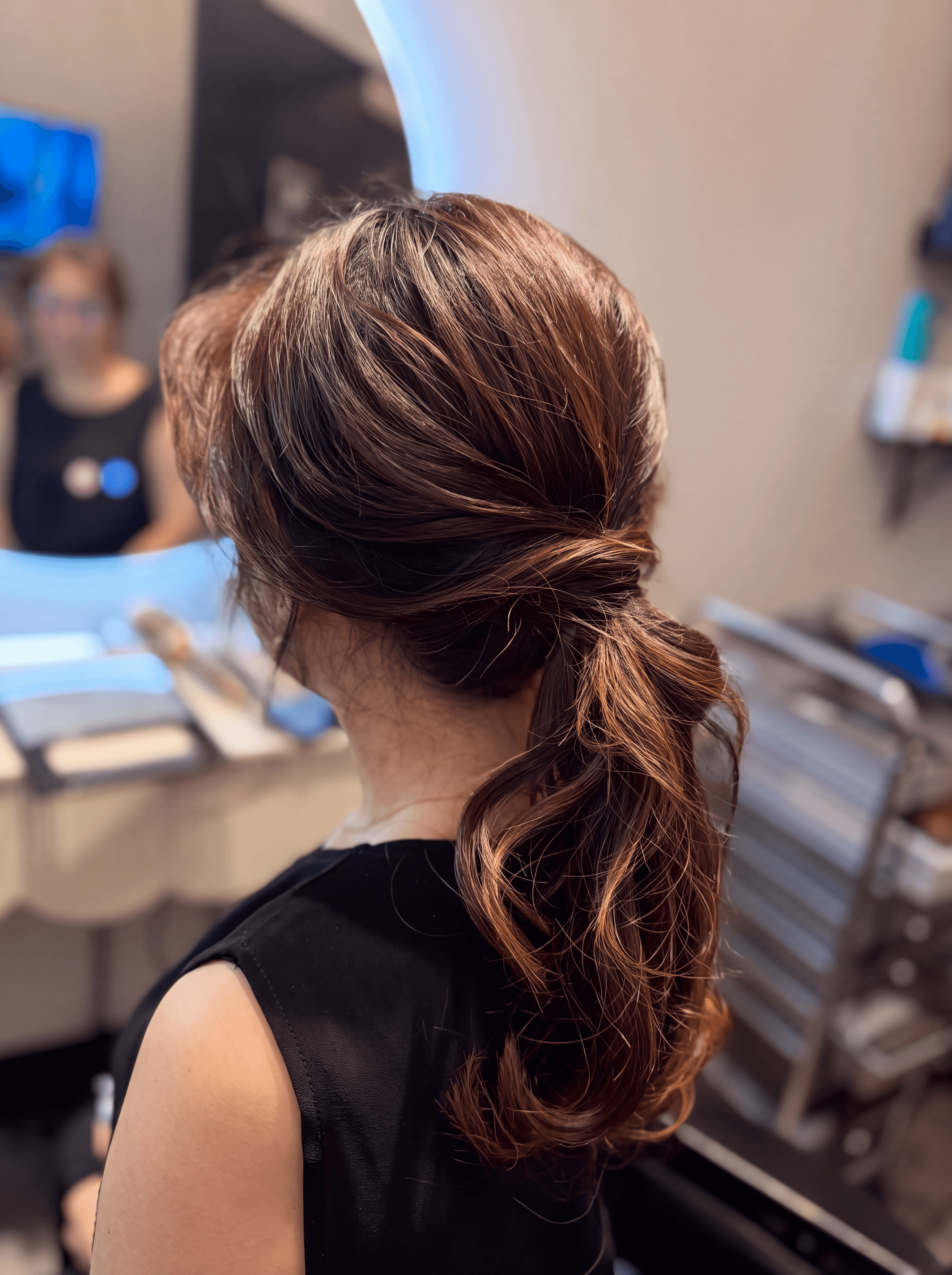 Elegant textured low ponytail hairstyle with soft highlights.