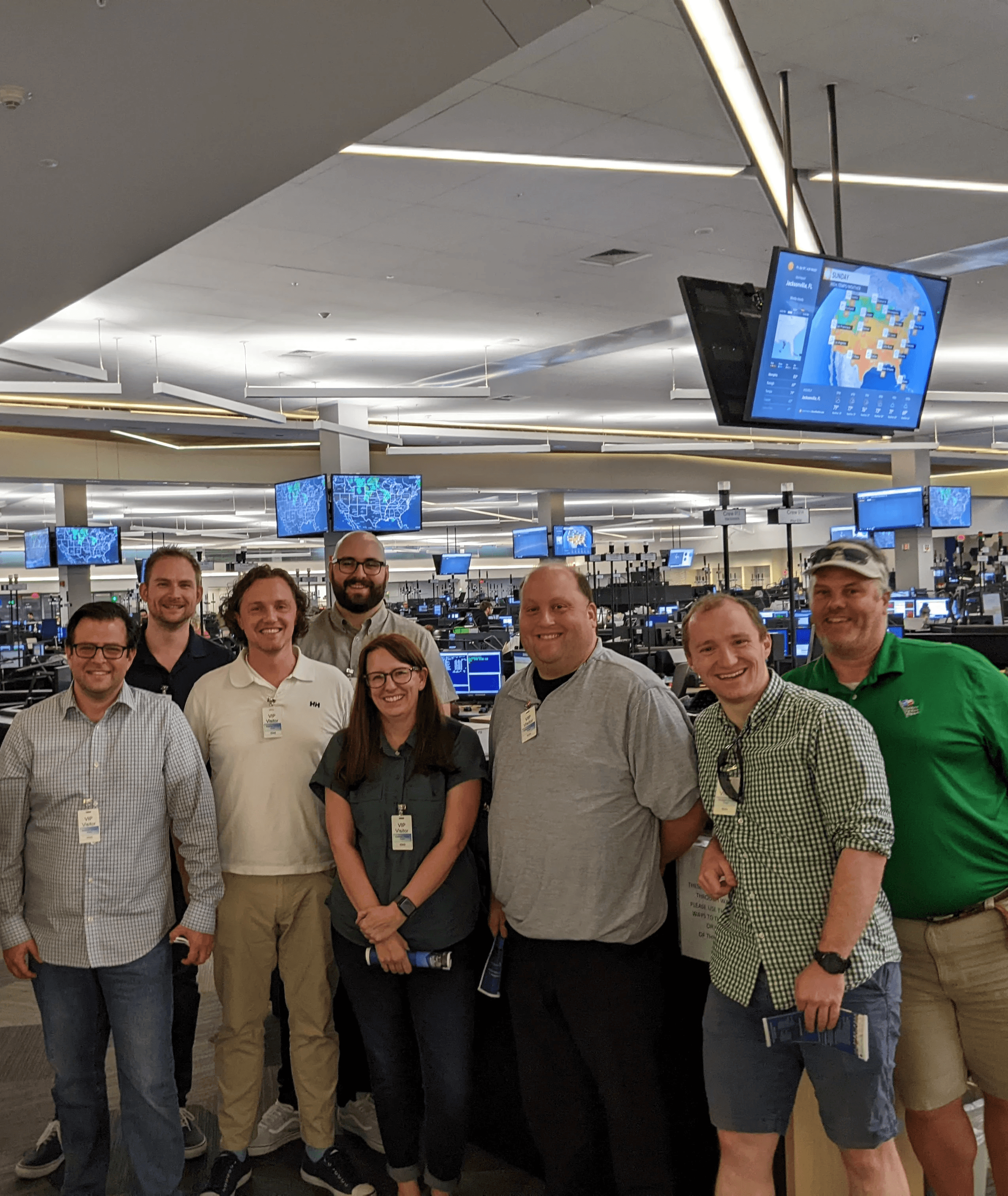 two agents working together while talking on the phone and looking at a laptop