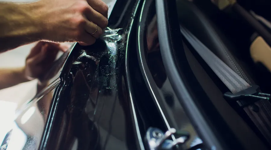 Applying protective film to car door edge