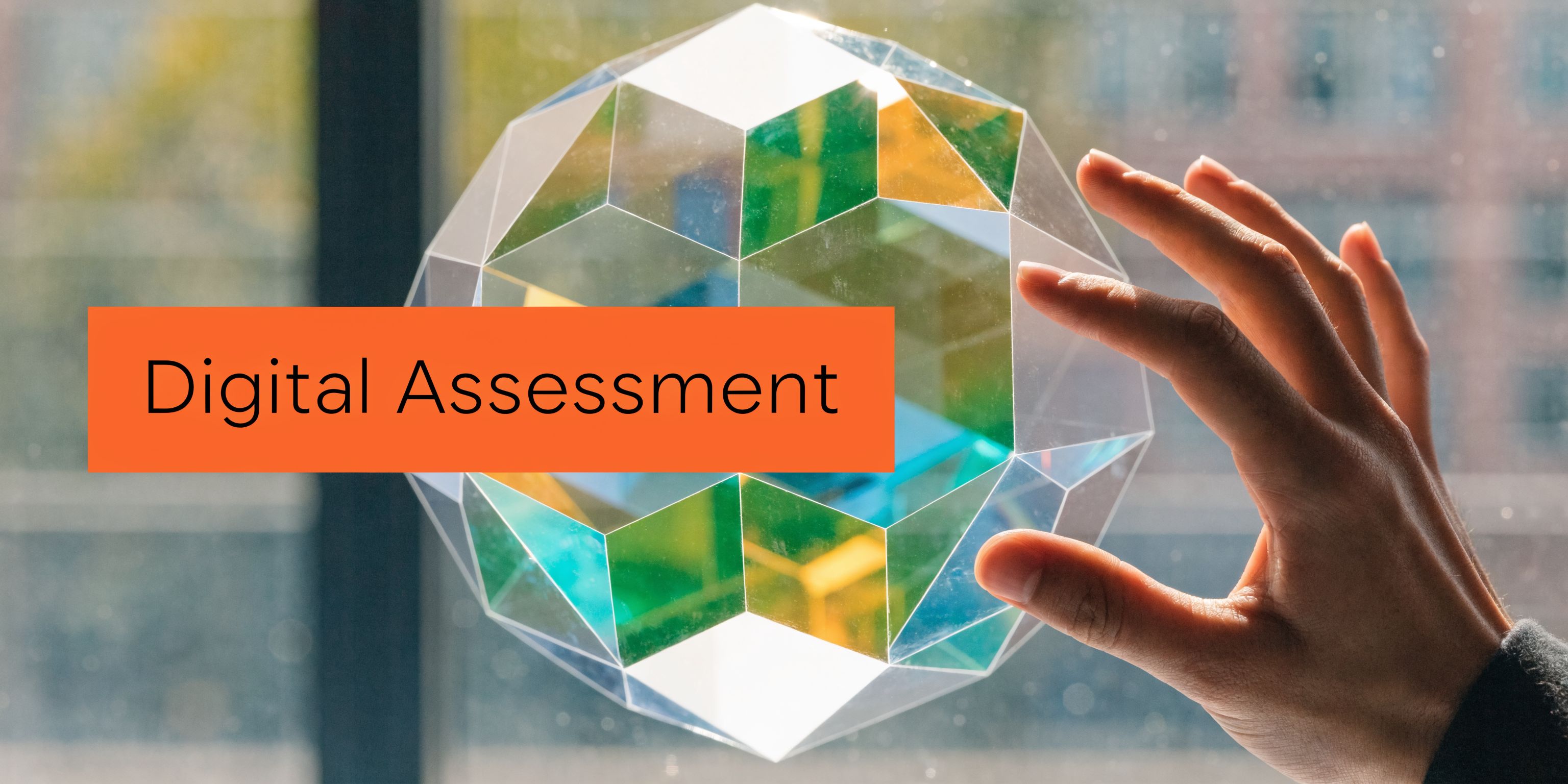 A hand touches a colorful geometric glass sculpture with the text Digital Assessment overlaid on the image.