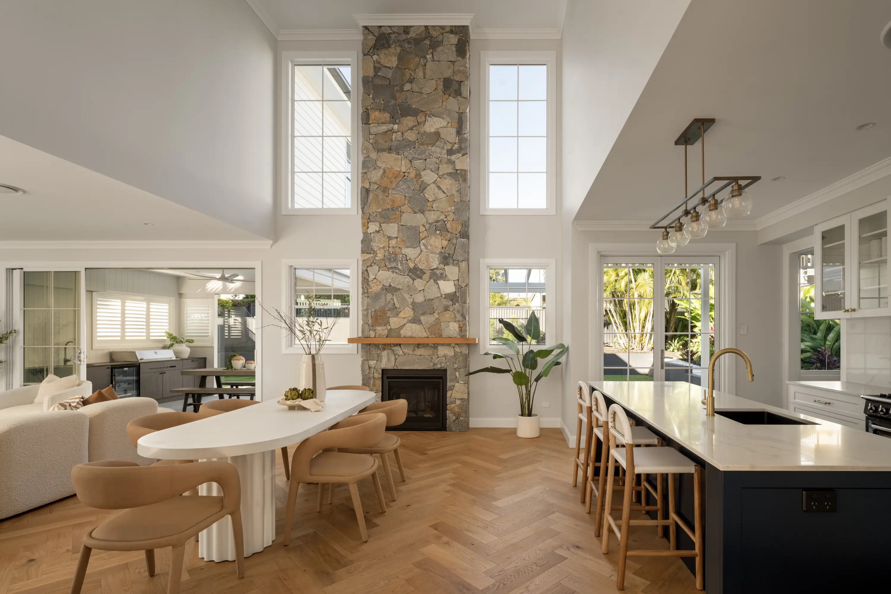 Interior of main living spaces in a narrow block home design filled with natural light