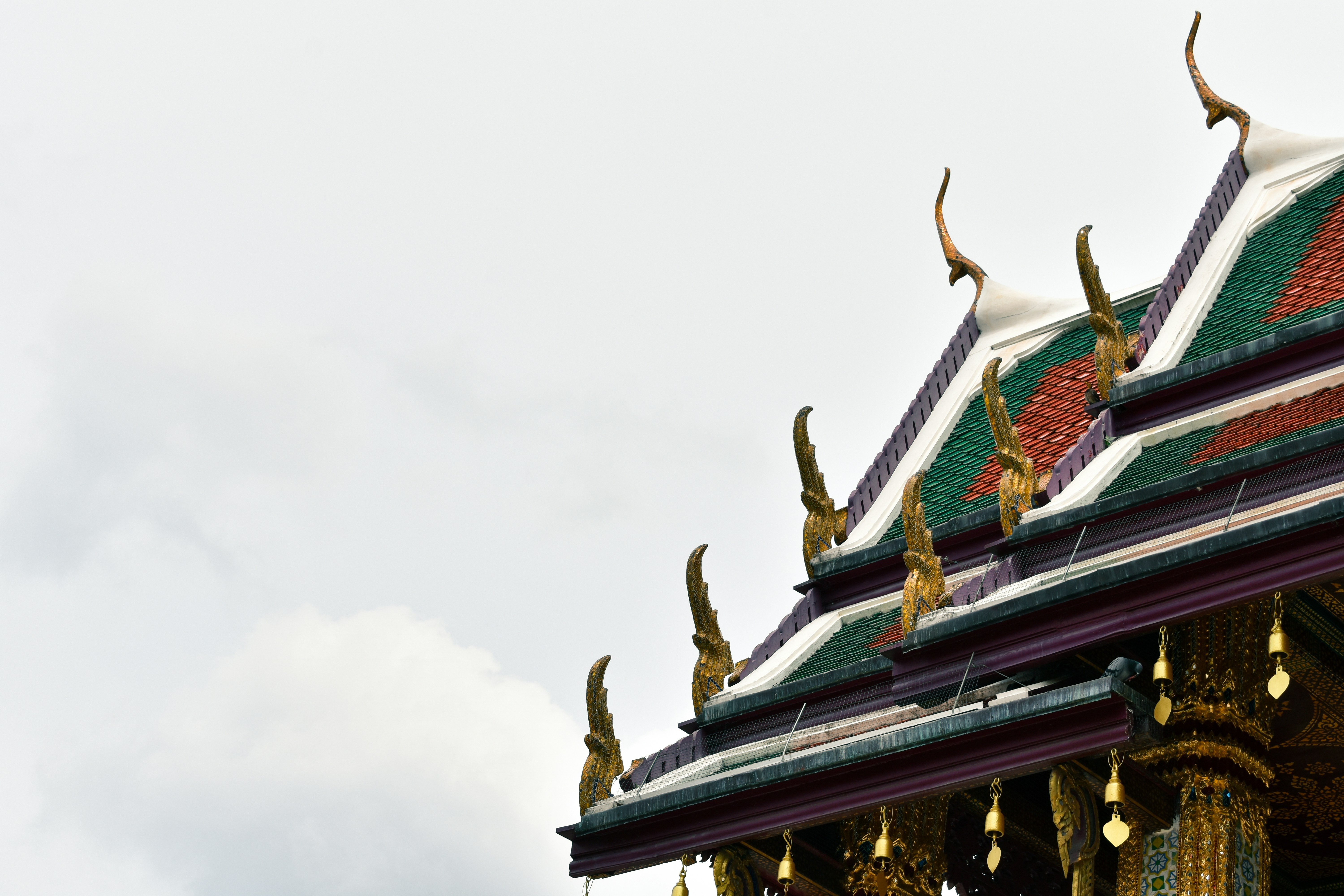 green and gold temple under white cloudy sky