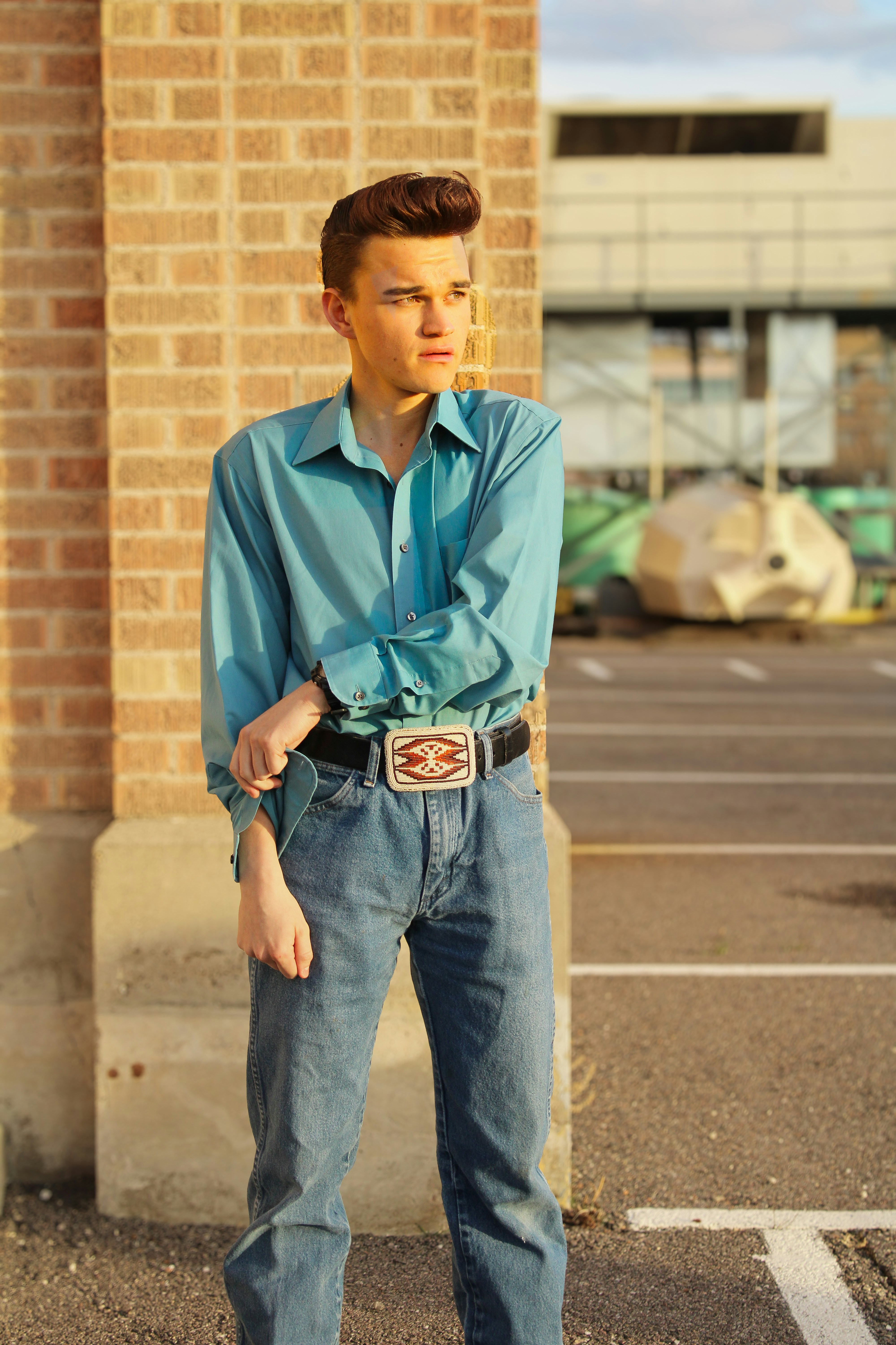 A man poses in a retro outfit outside.