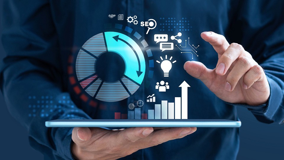 a person holding a tablet with a digital marketing pie chart and icons