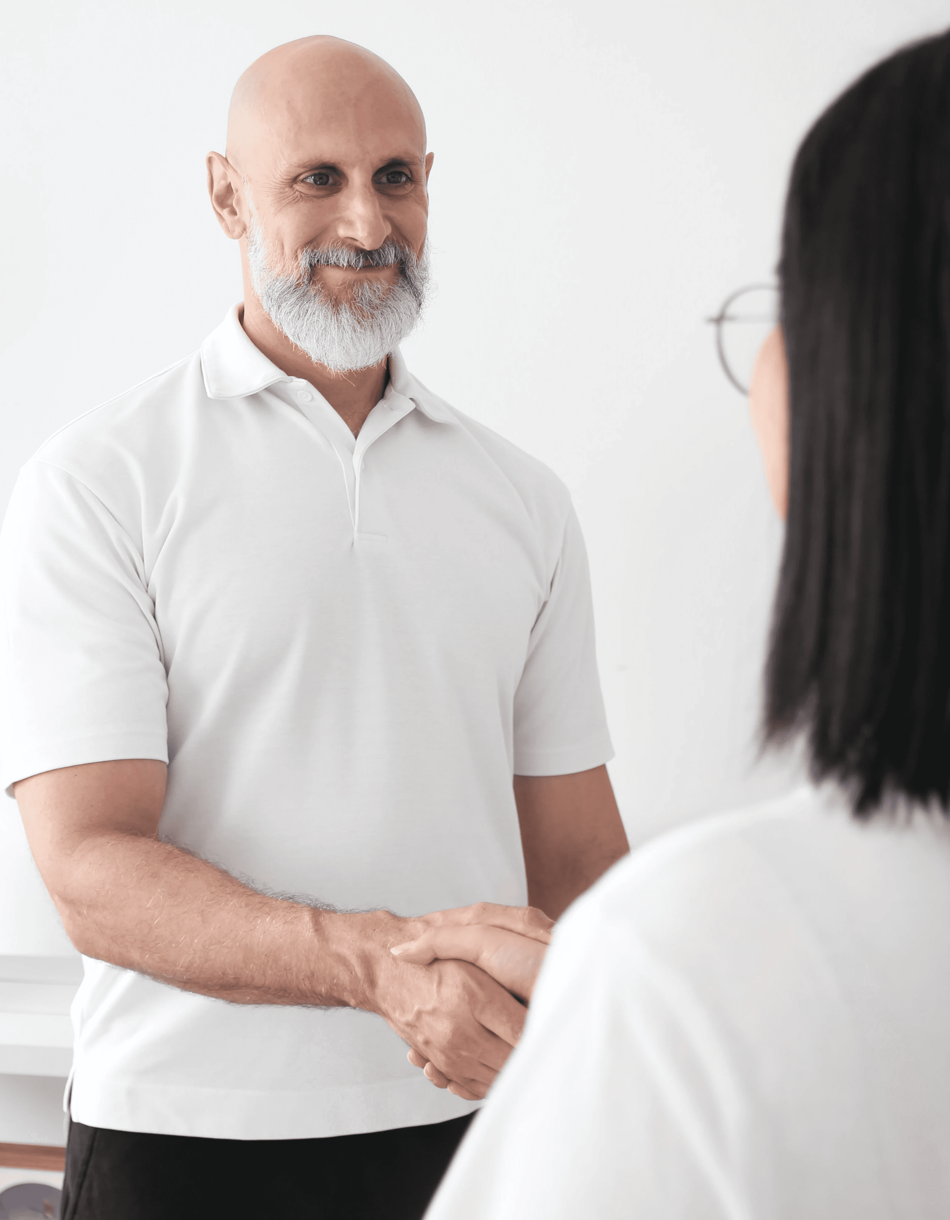 Close-up of a woman with under-eye gel patches, natural makeup, and smooth skin, against a neutral beige background