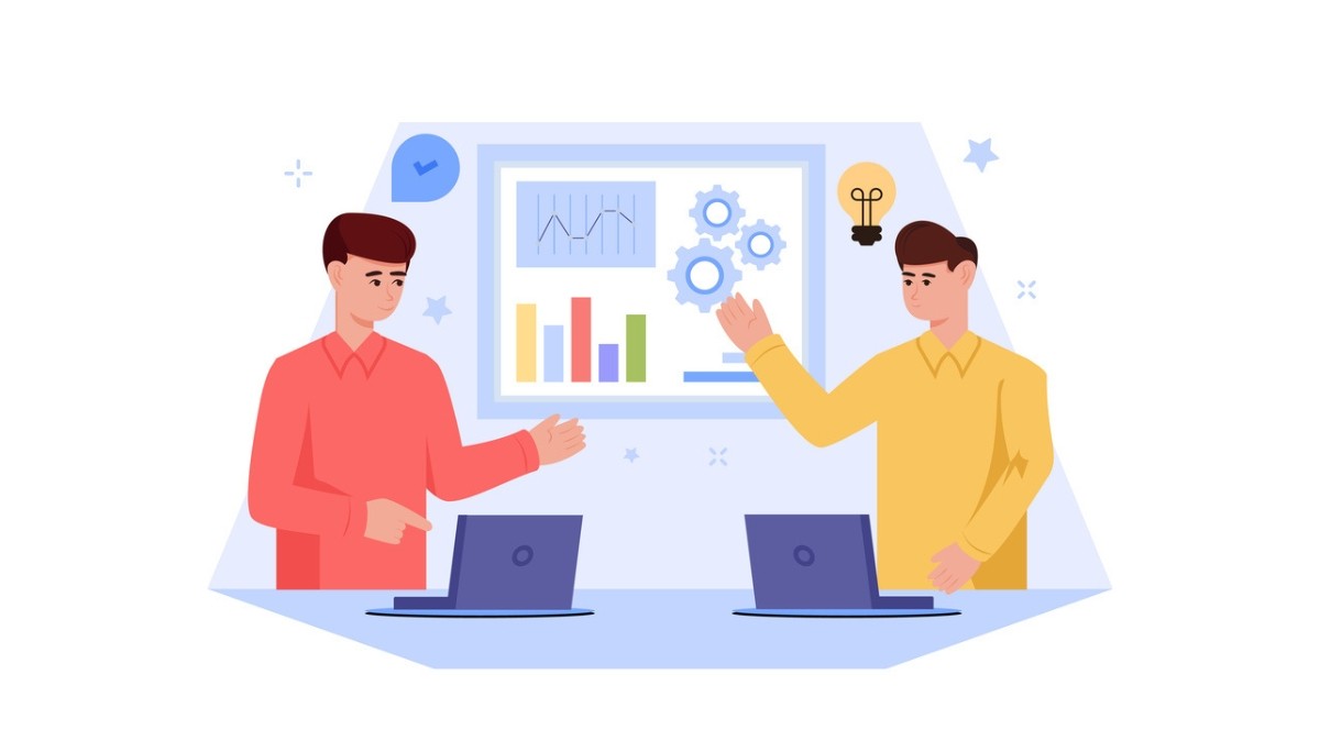 Illustration of two people seated at desks with laptops, discussing charts and graphs displayed on a large board behind them—symbolizing how thorough documentation, analysis, and clear communication distinguish senior engineers from others in the profession.