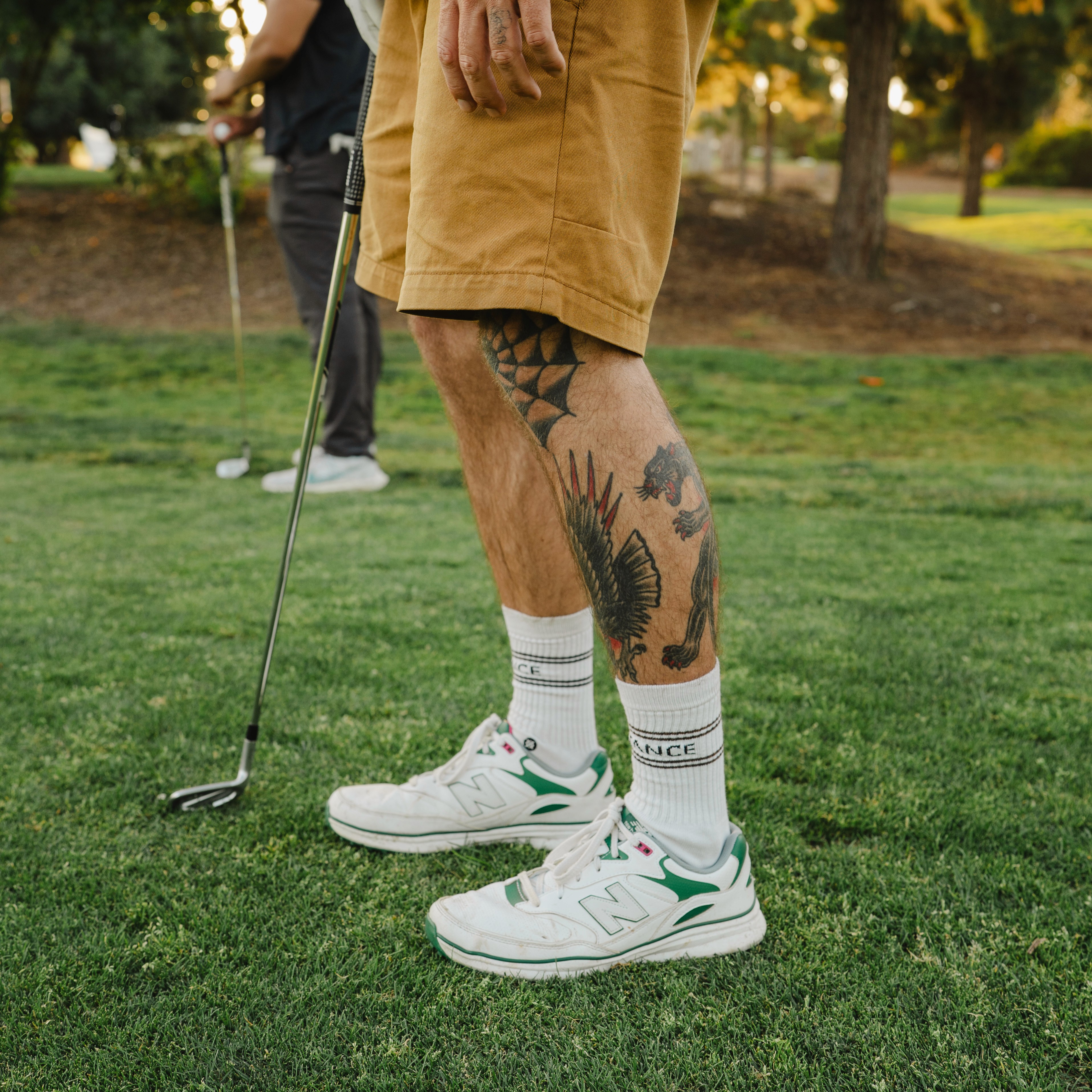 Black and white photo of two people looking at a computer screen with papers on wall
