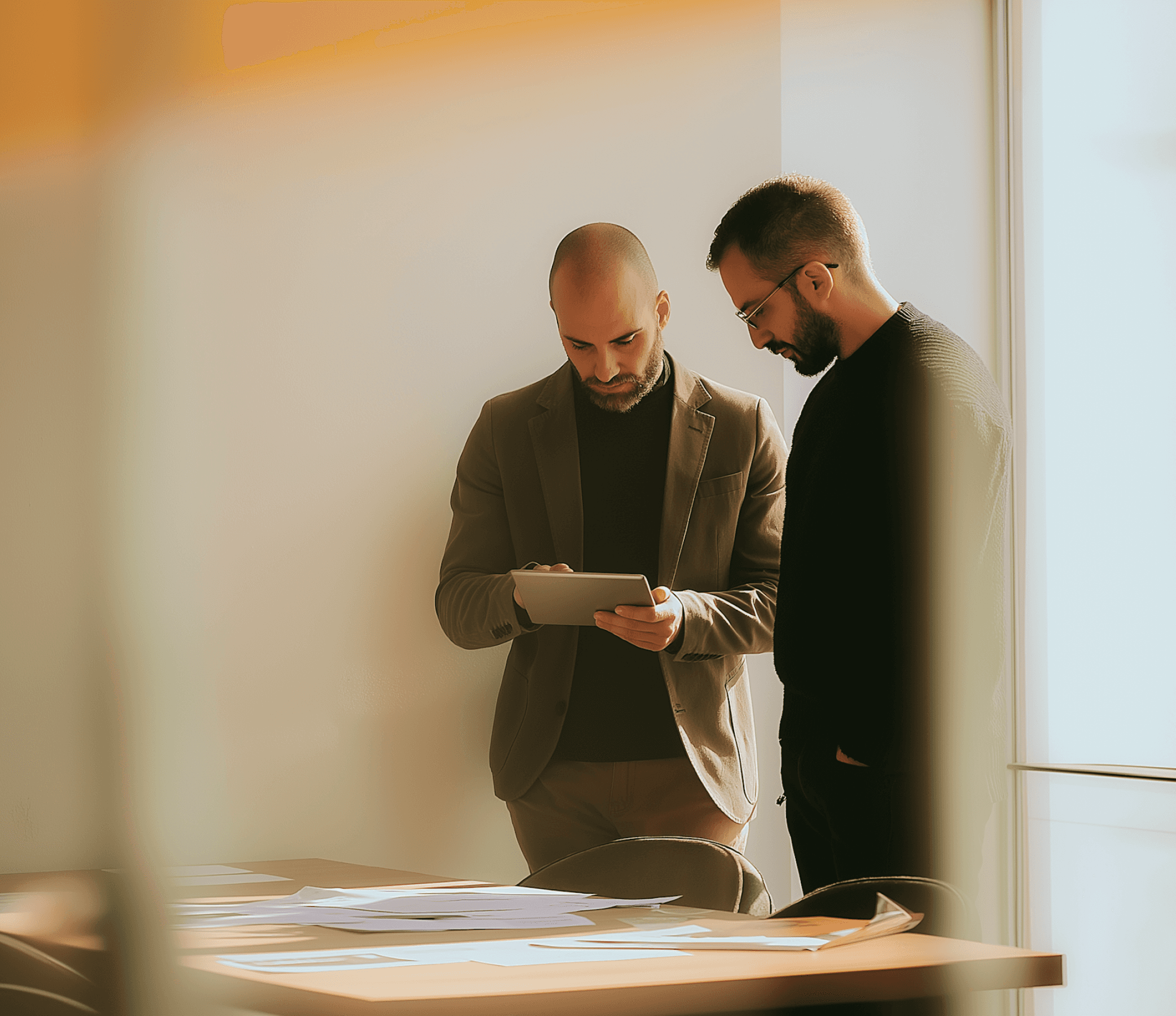Two executives reviewing a folder together."