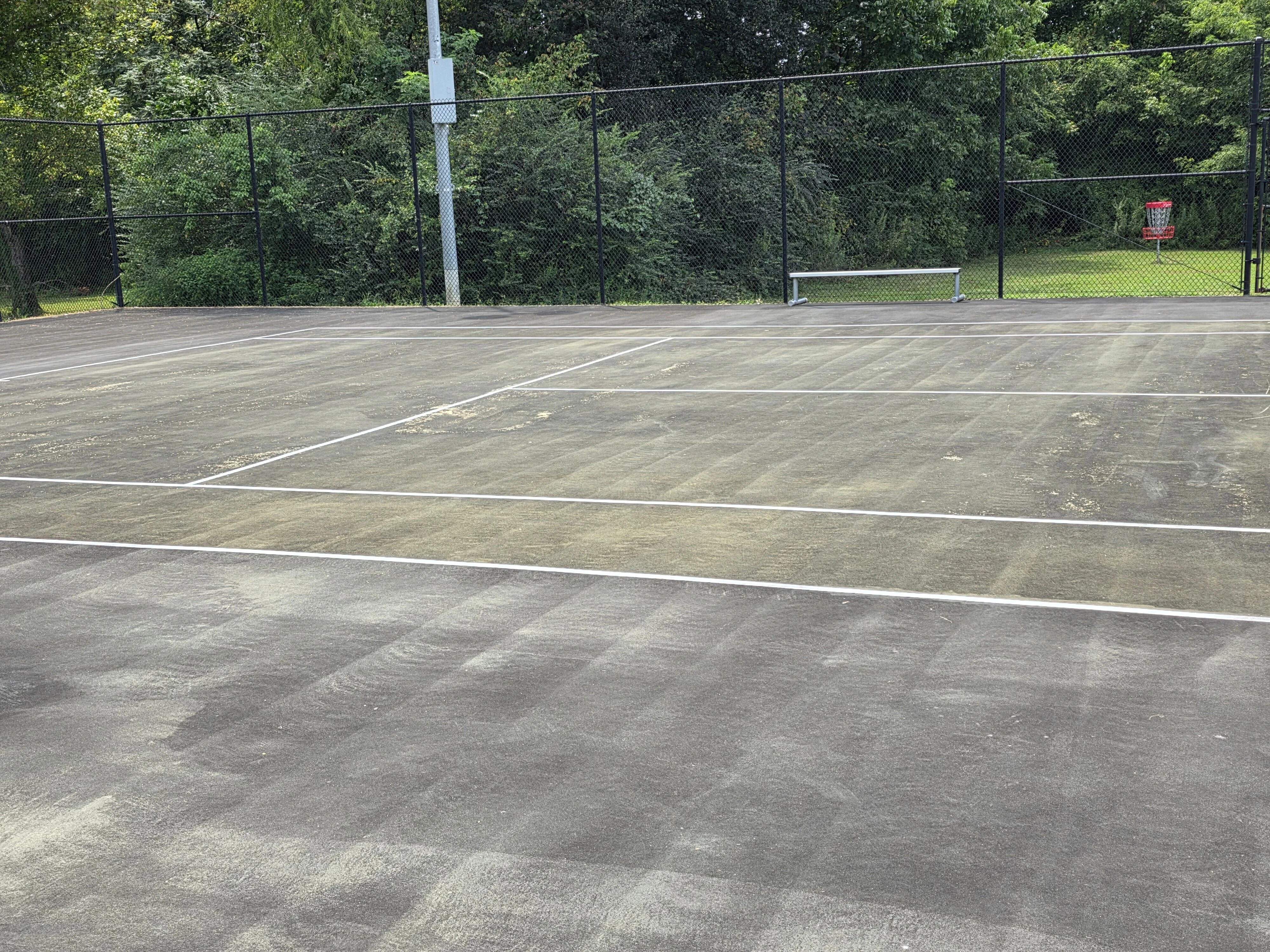 Faded pickleball court surface showing wear and deterioration at Corinth Parks & Rec