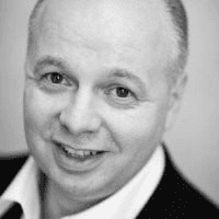 A person wearing a gray suit and tie.