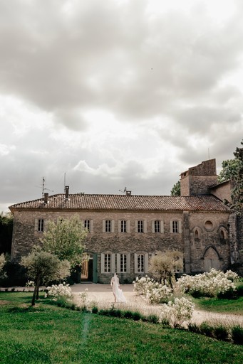 A vibrant bridal bouquet featuring a mix of red, pink, and purple flowers.