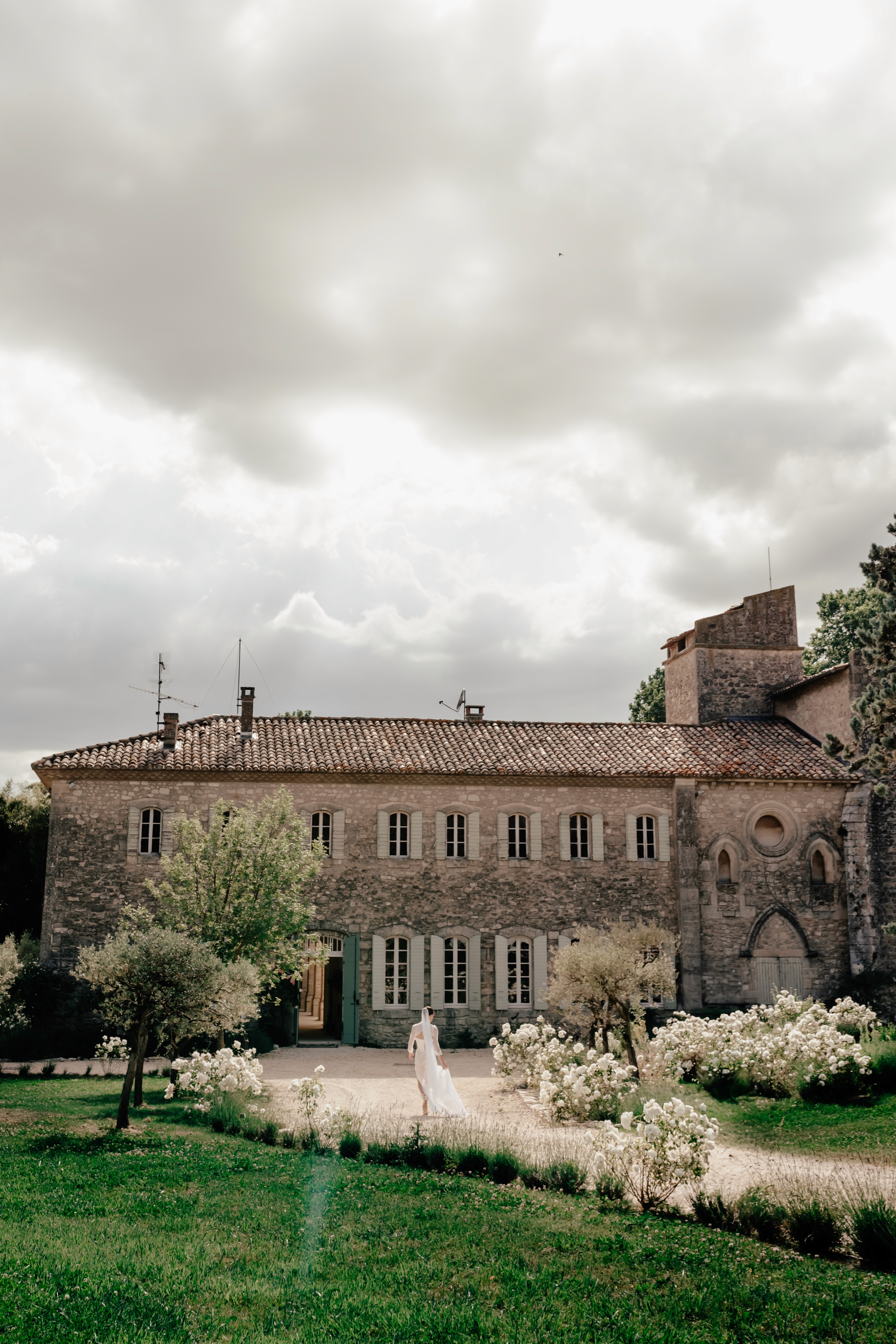 A vibrant bridal bouquet featuring a mix of red, pink, and purple flowers.