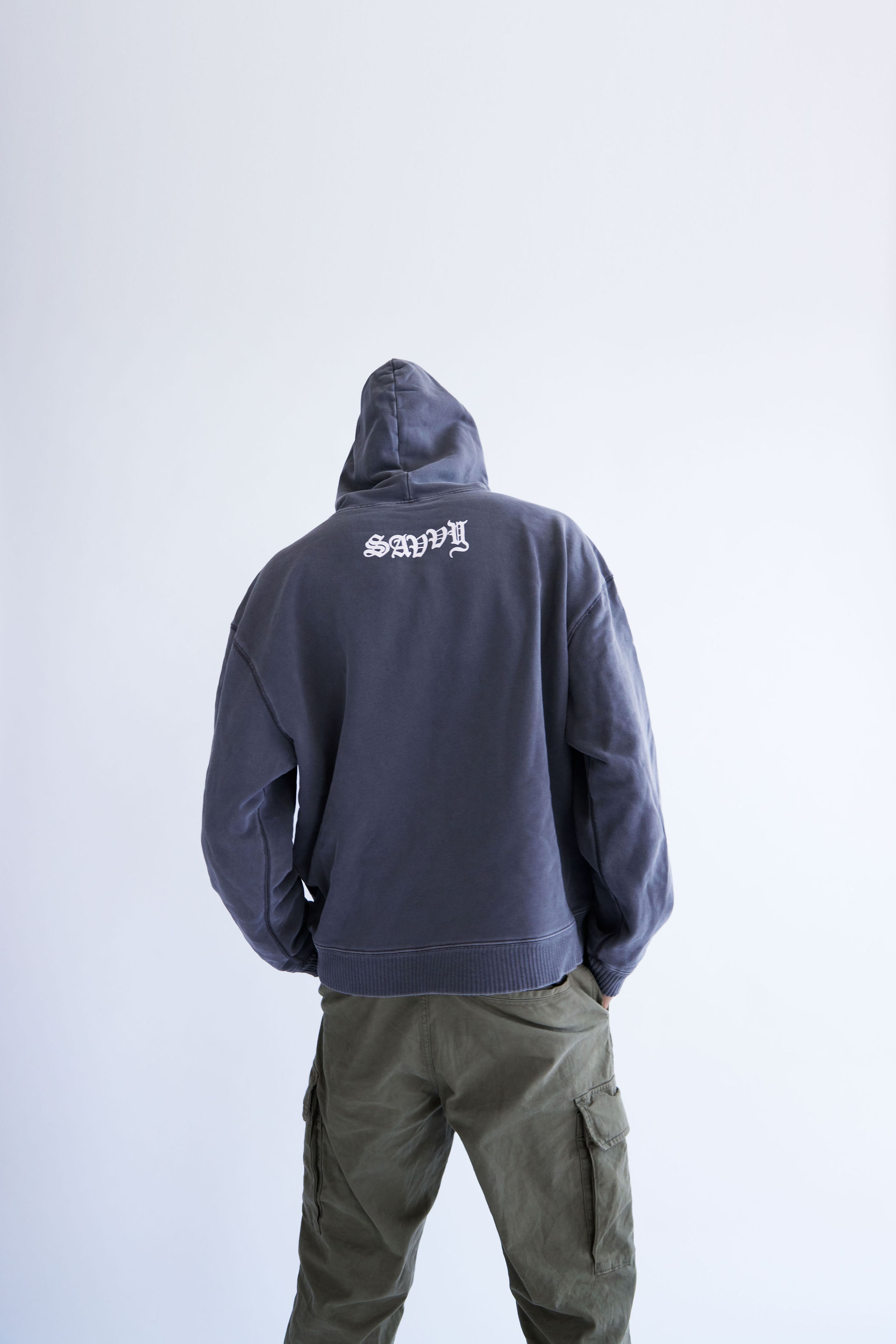 Young woman with dark hair and bangs, wearing red.