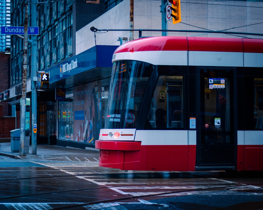 a red and white bus on a city street